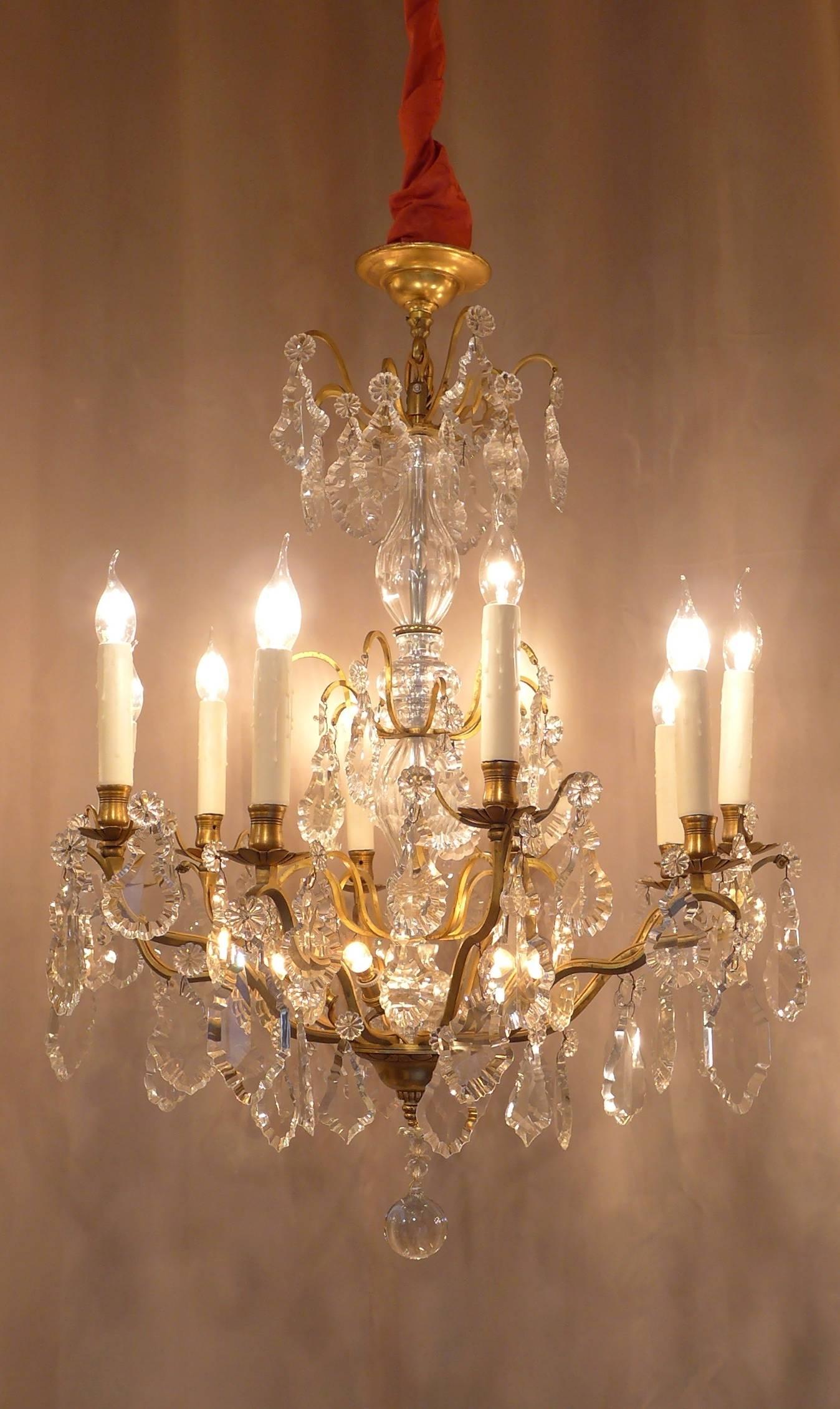 Lovely early-20th century, pair of original gilt bronze and crystal chandeliers in the classical Louis XVI style with interesting dimensions of 37.40 in. height. Each chandelier is composed of ten-arm lights, five internal light in the center, lot