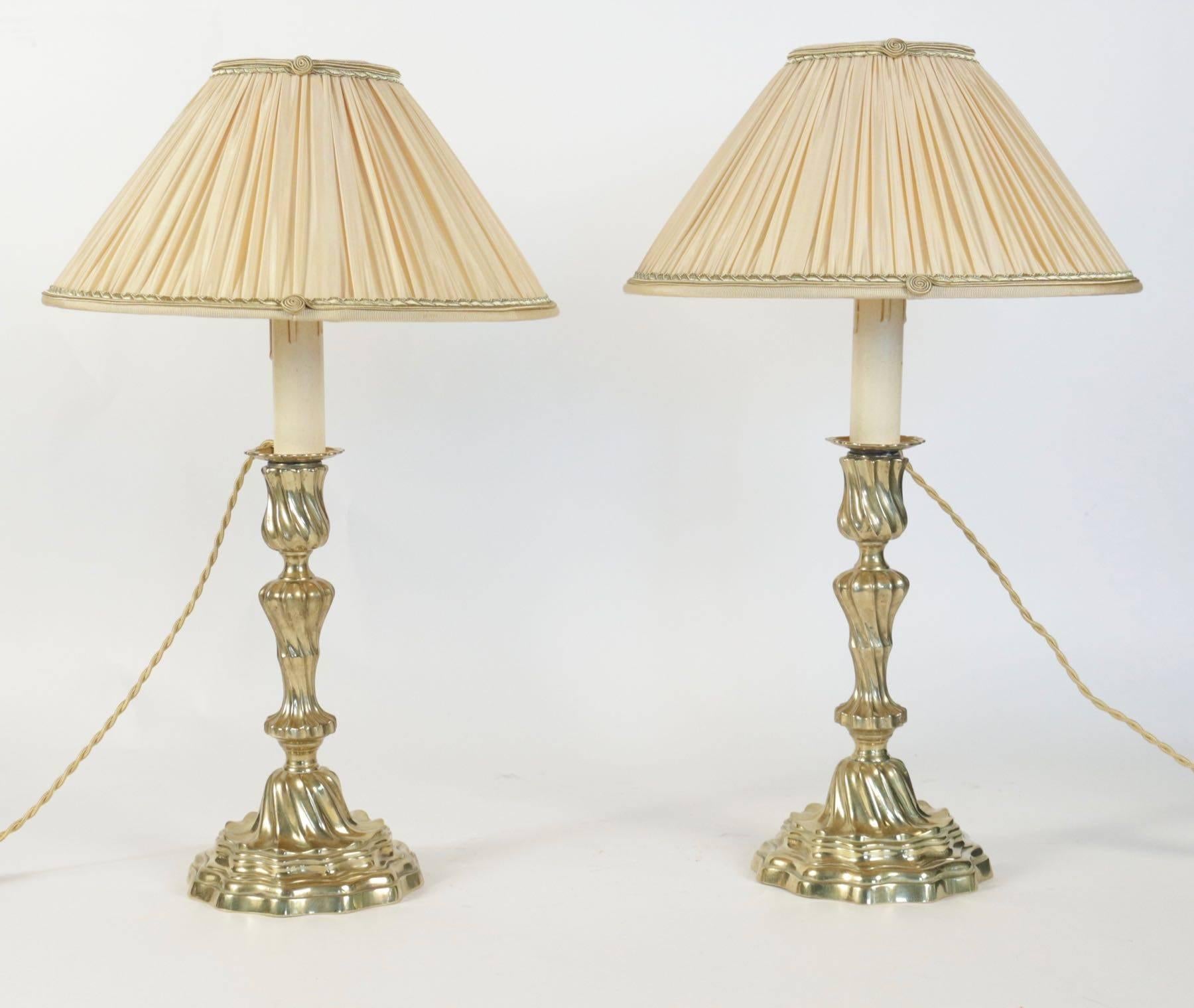A nicely pair of Louis XV period original gilt bronze candlesticks. The candlestick rests on a circular base.
The candlesticks converted to table lamps with new pleated light yellow and gilded band silk lampshades.
French work, circa 1760.