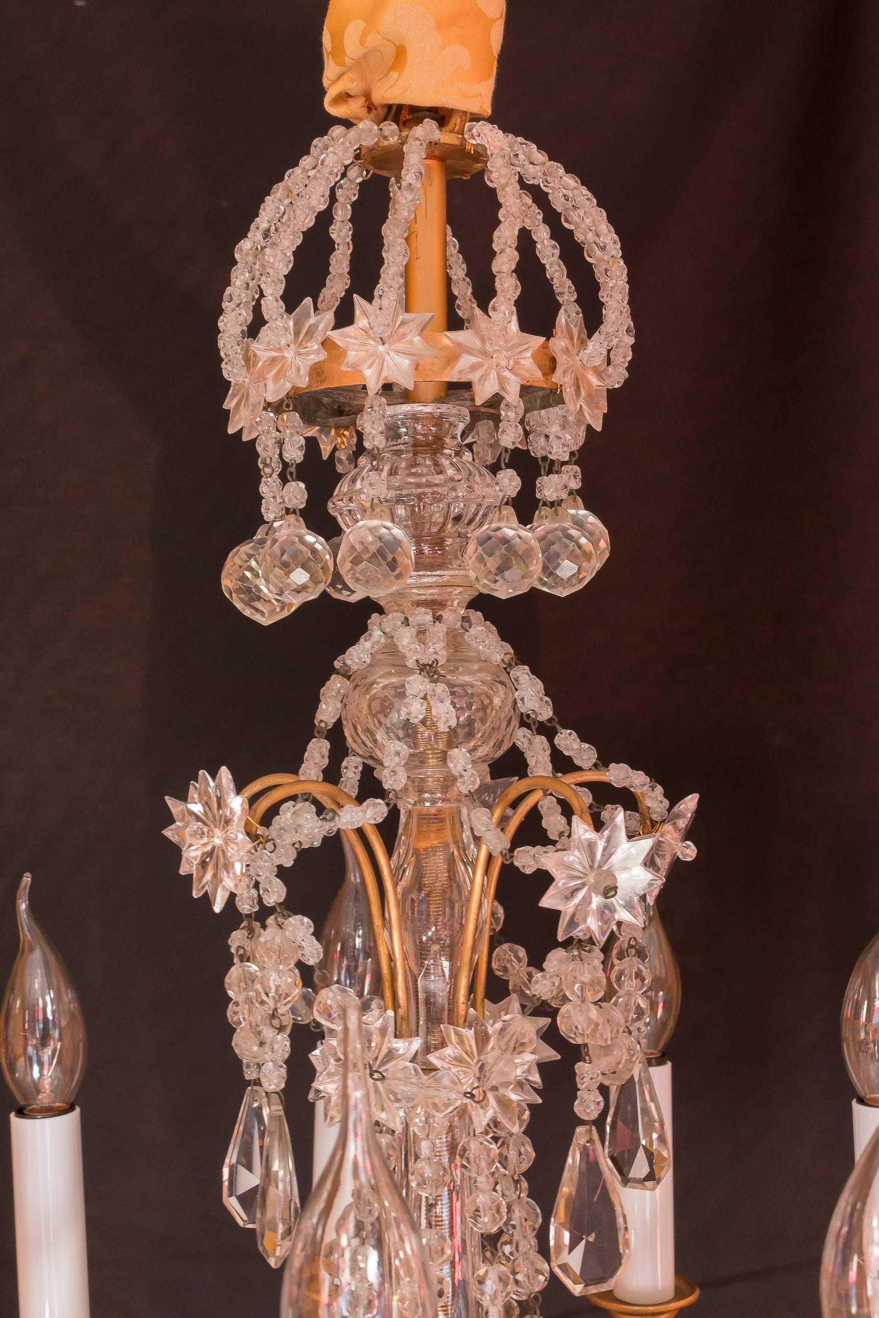 Amazing an decorative original gilt bronze and hand-cut crystal small chandelier in a classical Louis XIV style. Interesting top crystal crown and lot of fine quality hand-cut crystal, little balls, plaques and pearls. It is terminated by a lovely