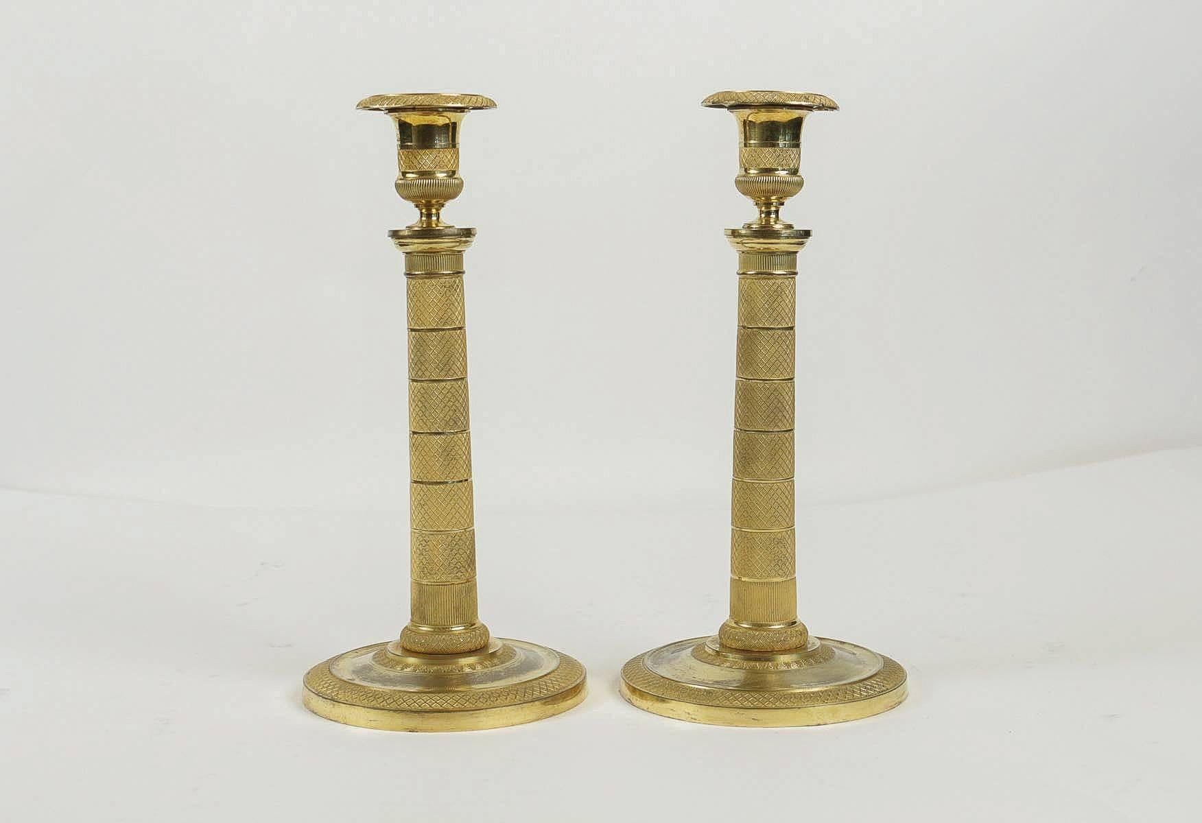 A gorgeous pair of Empire period candlesticks finely chiseled in very beautiful original gilding. The candlestick rests on a circular base,

early 19th century, French work, Empire period, circa 1810.

Dimensions: 9.84 in. H, 5.51 D circular