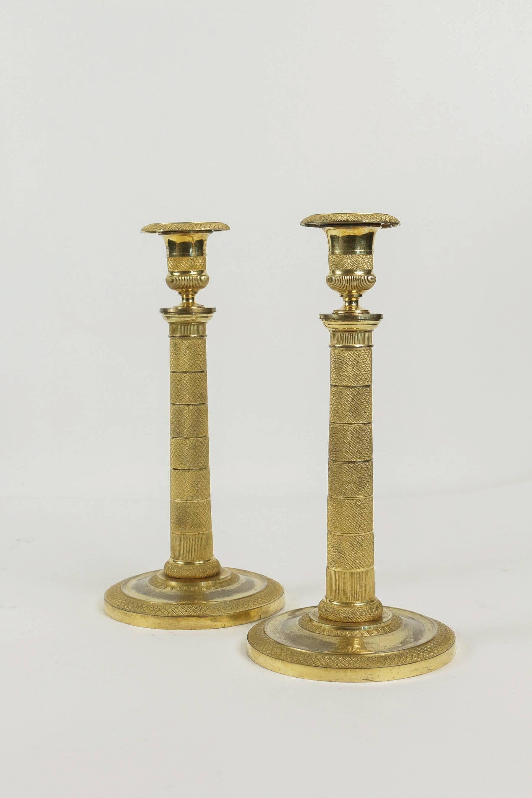 Gilt Early 19th Century Pair of French Empire Period Ormolu Candlesticks, circa 1810