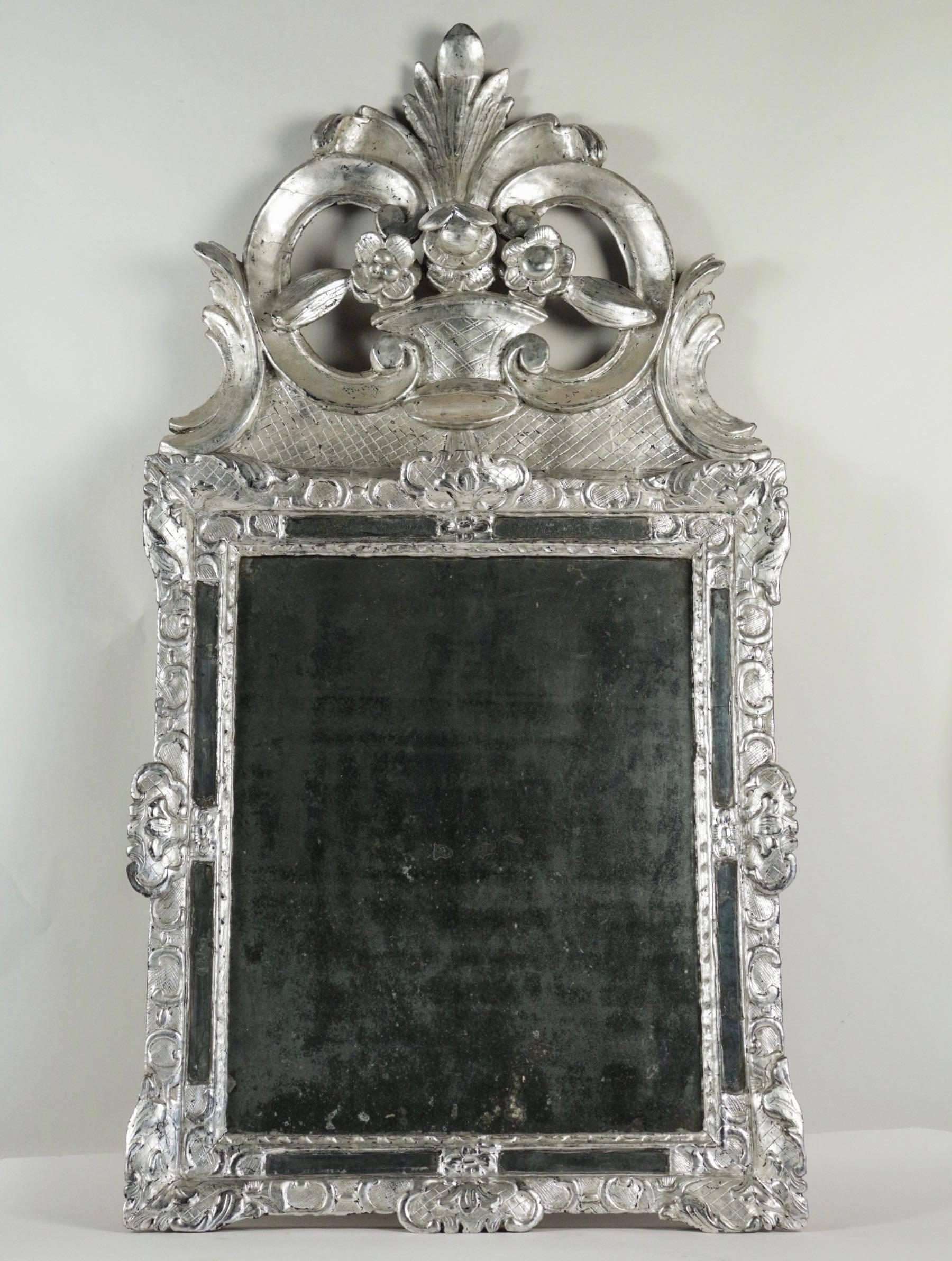 Gorgeous silvered wood mirror with original mercury glass. The hand-carved frame representing Berain decor style. Hand-carved front top.
French Louis XIV period, early-18h century, circa 1700.