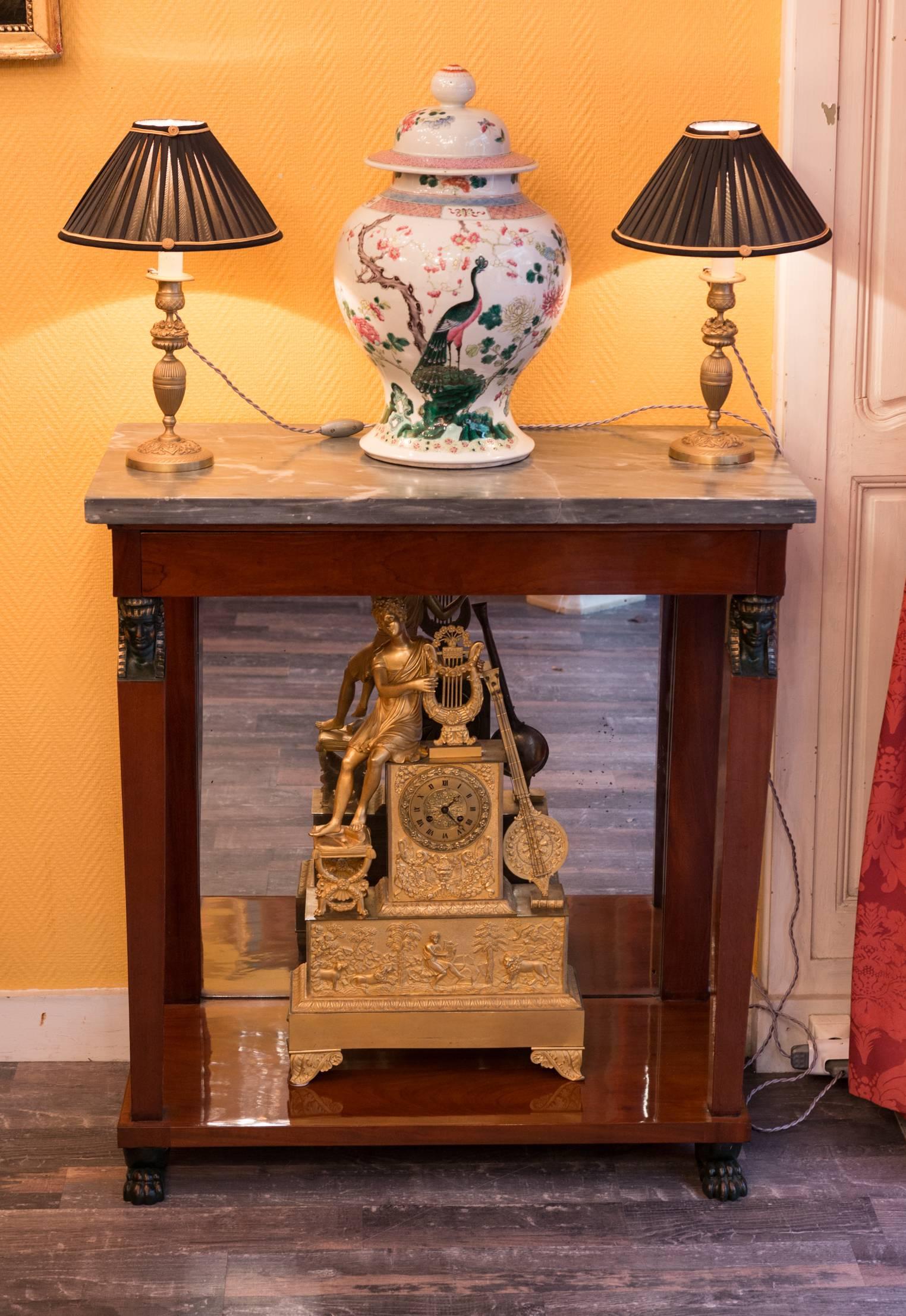 A lovely, fine and rare French Consulate period mahogany and mahogany Honduras veneer artistic console, with “Bleu de Turquin” marble-top. This console with its simplicity of design, with its finely detailed patinated hand-carved wood mounts, make