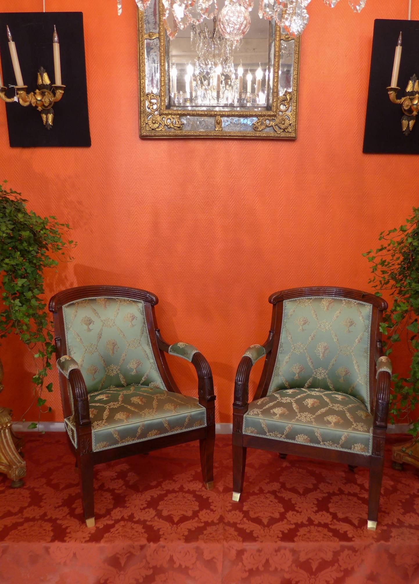 Gorgeous large pair of Empire period hand-carved solid mahogany and veneer mahogany armchairs. 

This extraordinary large Empire period armchairs has been recently reupholstered in a fabulous green celadon fabric by Tassinari that works magically
