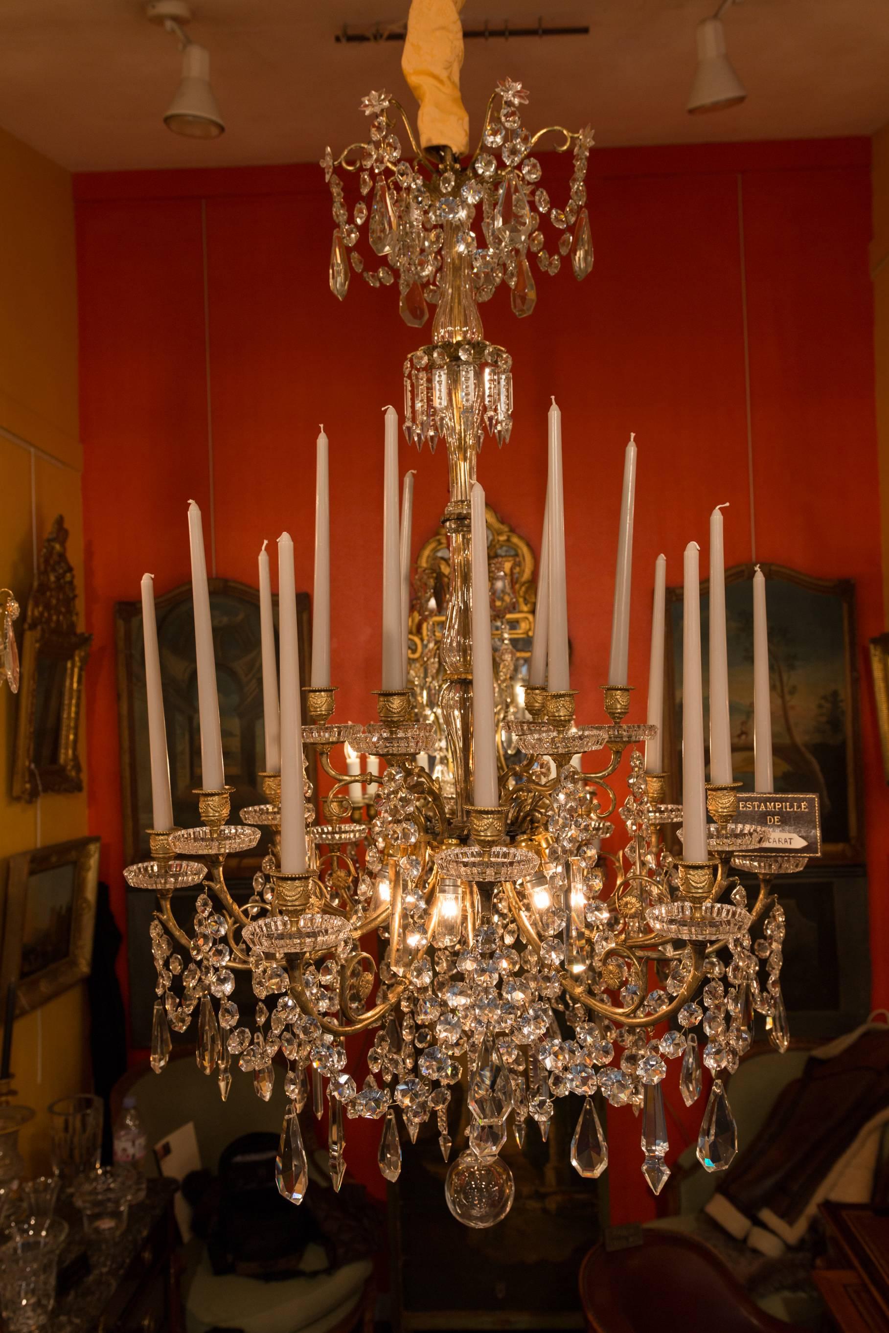 Gorgeous, original ormolu and hand cut crystal, form 'tige' chandelier in the classical Louis XVI style. Our chandelier is composed of eighteen-arm lights.
Six interior lights has been professionally wired for electricity.
Baccarat top quality