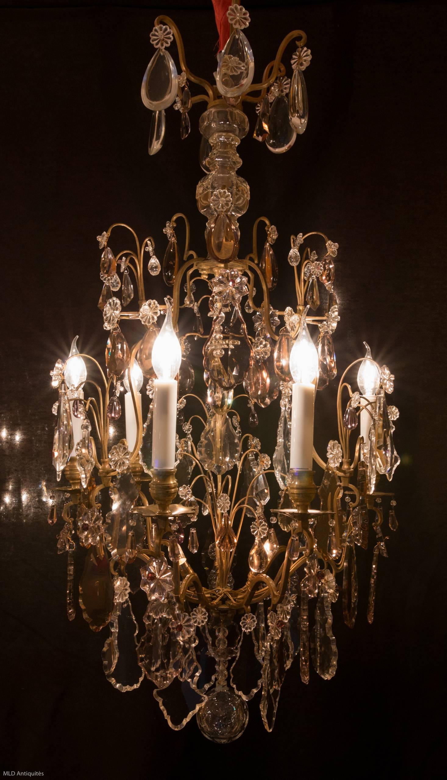 Gorgeous, original gilt bronze and crystal, form cage chandelier in the classical Louis XV style. The chandelier is composed of six perimeter arm lights and three internal lights. Very Fine quality white and amethyst hand-cut crystal pieces,