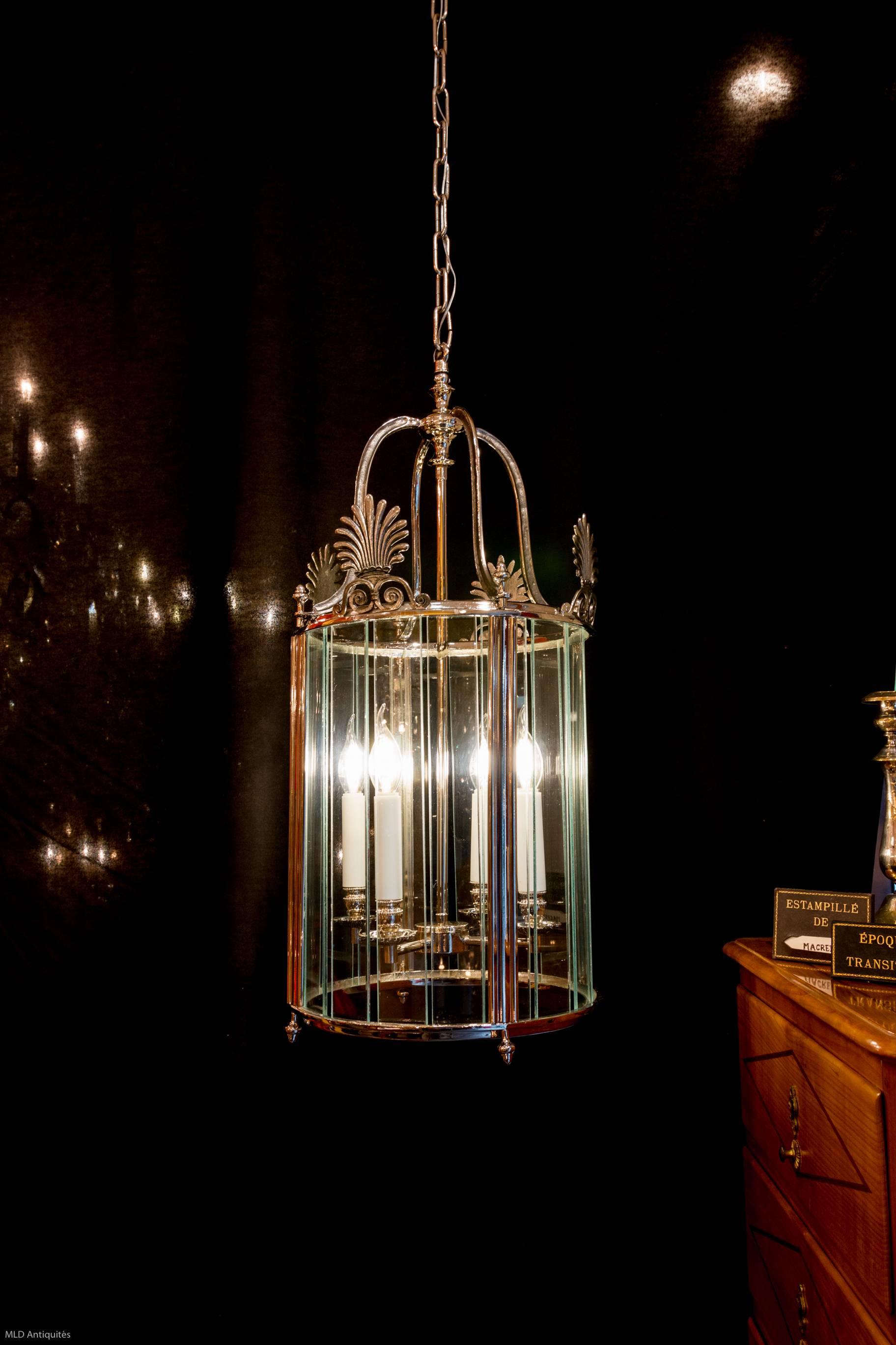 A lovely early 20th century French Empire style silver plate lantern. The lantern is in perfect condition and it has been professionally wired for electricity. Measures: 29.52 in. H, 13.38 in. D.