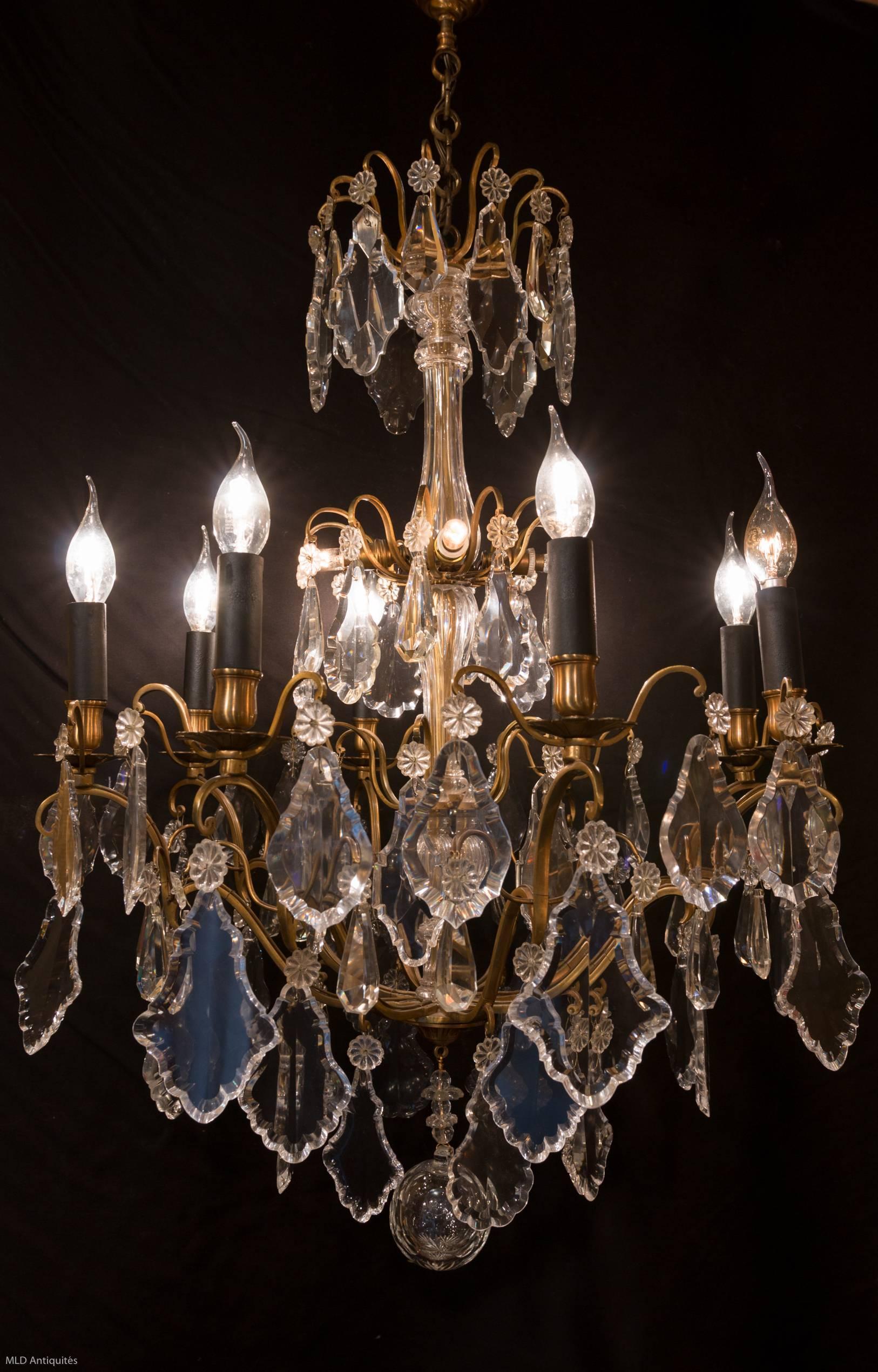 Gorgeous, original gilt bronze and crystal, form cage chandelier in the classical Louis XV style. The chandelier is composed of height perimeter arm lights and three internal lights. Very fine quality white hand-cut crystal pieces, plaques and a