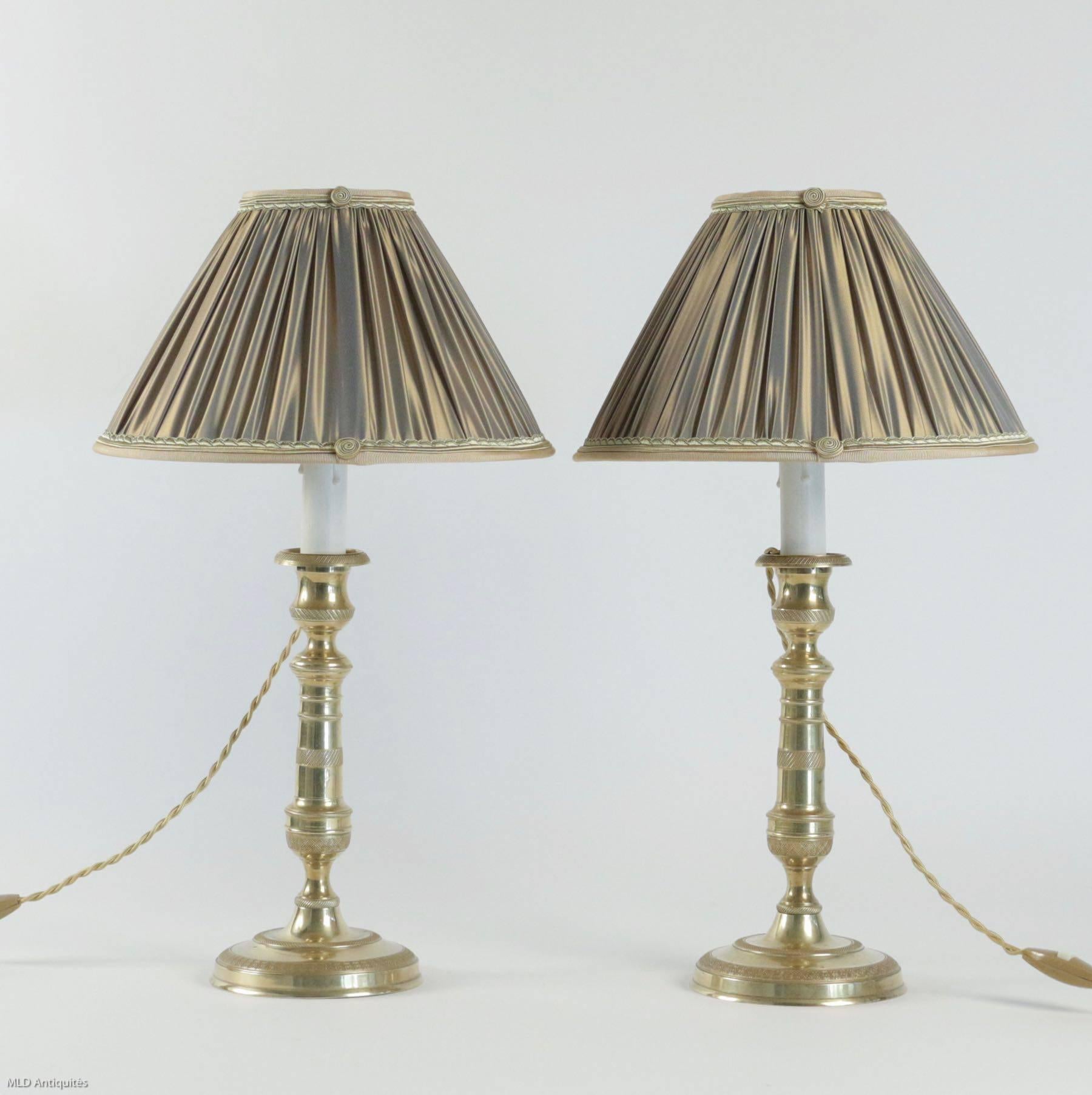 Pair of nicely-chased French Louis XVI Period, original gilt bronze candlesticks, very finely chiselled, converted to table lamps, with new French pleated cream color silk lamp shades.
French work late-18th century, Louis XVI period, circa