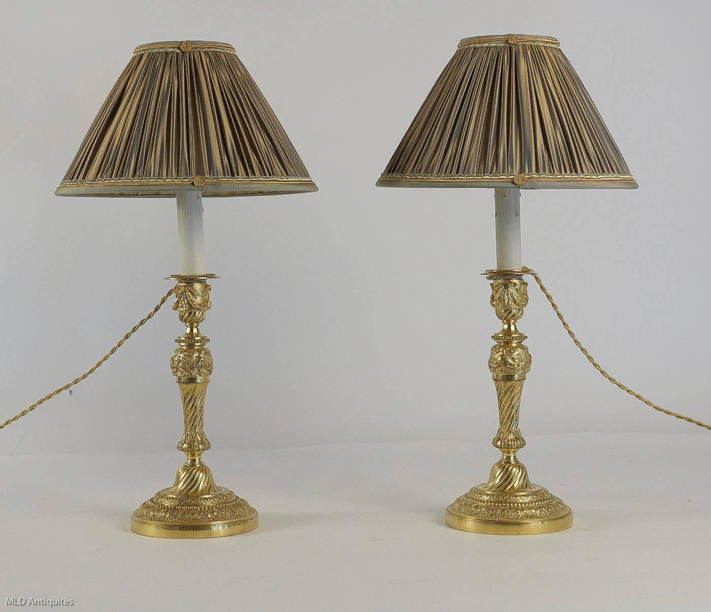 Pair of lovely French Louis XVI period, original mercure gilt bronze candlesticks, very finely chiselled with foliage’s, grapes, water pearls, converted to table lamps, with new French pleated changeable beige colour silk lamp shades.

French work