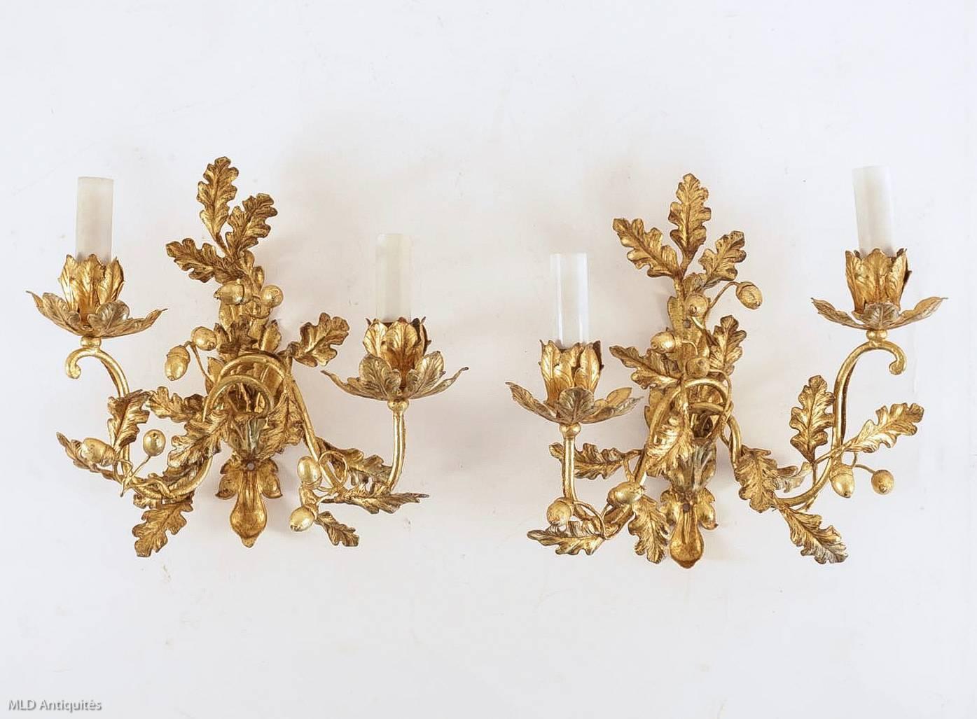 We are pleased to present you an interesting and lovely pair of French, two lights, guilt-iron sconces, with acorns and oak leaves.
Very beautiful original gilding.

Fine original condition. It has been professionally wired for