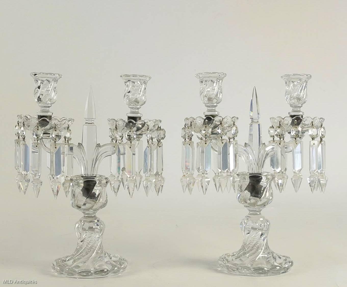 We are pleased to present you a lovely and fine cut crystal pair of candelabras, with two candlesticks arm-candlestick lights, with cut crystal pendants on the candle cups, raised on a circular cut crystal base.

A lovely French work late 19th