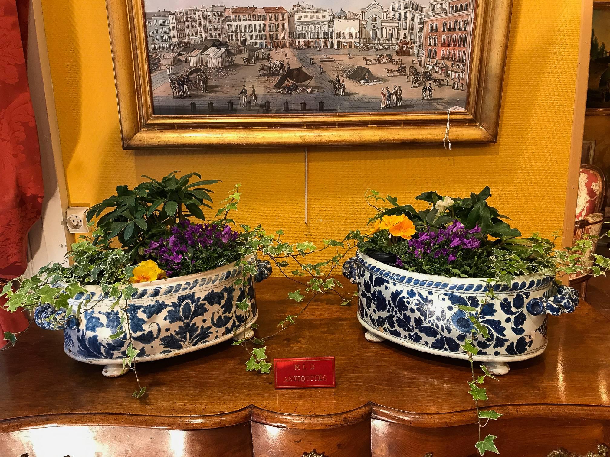 We are pleased to present you a rare set of great planters, or « rafraichissoirs » (wine or water cooler) in faience to twisted handles resting on three feet, decorated in « blue camaieu » of stylized flower garlands. 

Gorgeous and rare work in