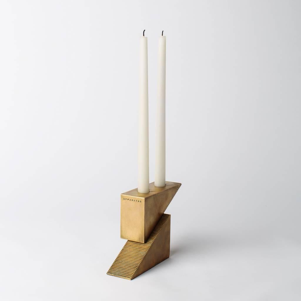 Inspired by precision studio tools, candle blocks are triangular forms with fine interlocking teeth that allow the creation of modular arrangements. A set of two triangular blocks can be positioned to burn either one or two taper candles, while