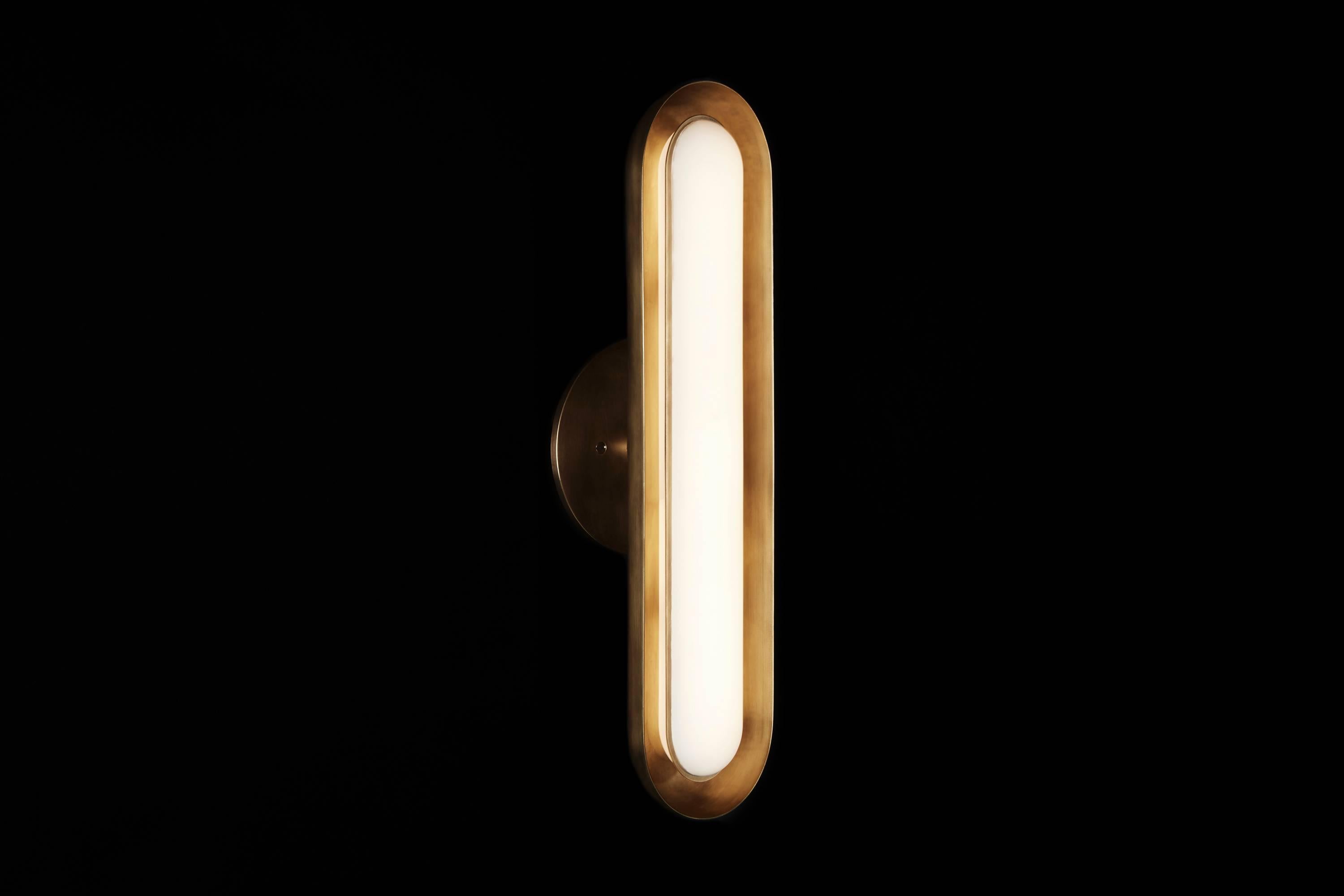 The Circuit series creates rhythm with the repetition of pure shapes. A glowing glass capsule nests in a brass shade, becoming a contained form that multiplies to construct larger fixtures.

The Circuit 1 has a specially developed, warm LED light