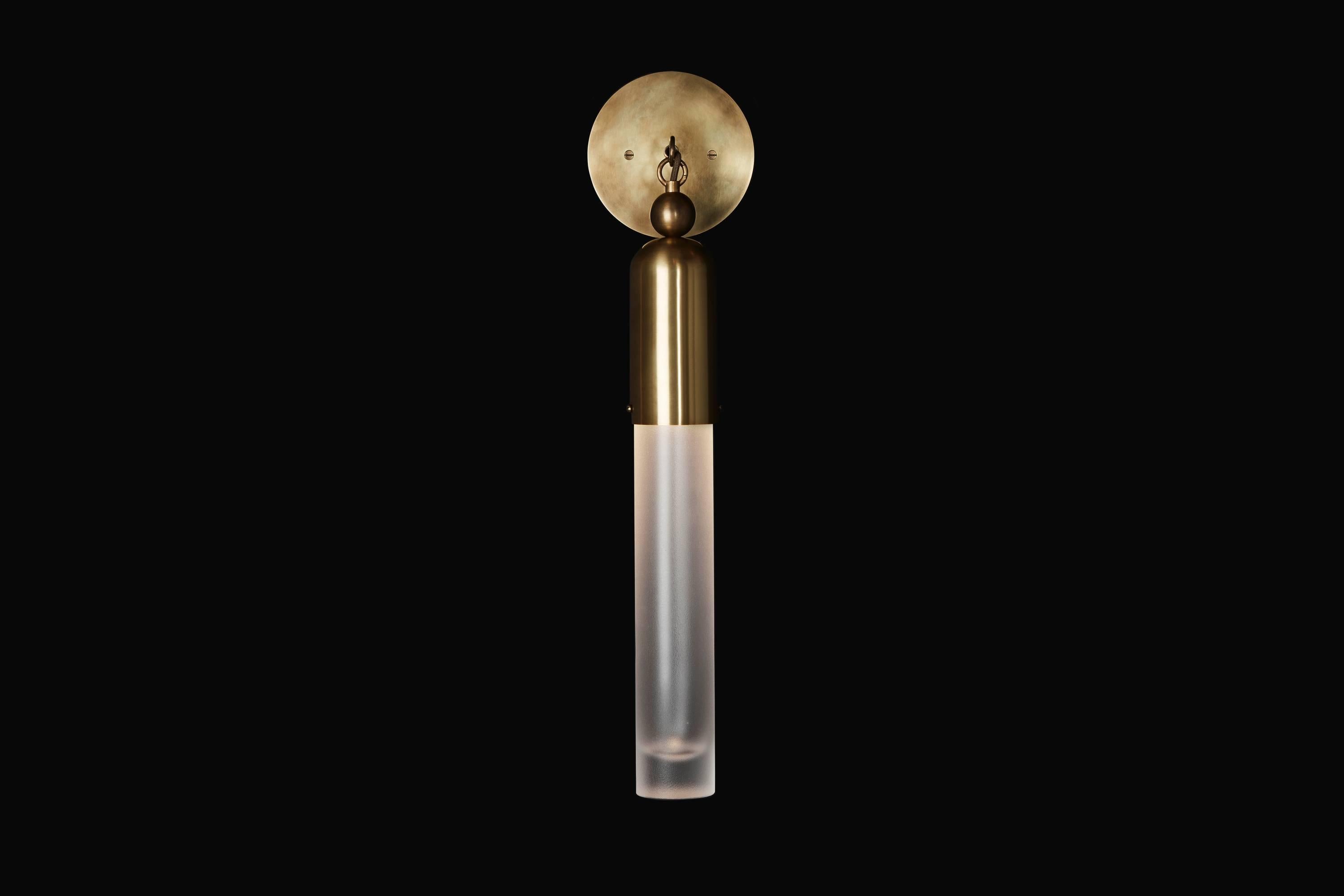 The Tassel series condenses the warmth and decadence of a traditional chandelier to a concise, modern conclusion. Emanating from a brass dome, the light is amplified as it refracts through mold-blown glass cylinders.

The tassel one sconce uses a