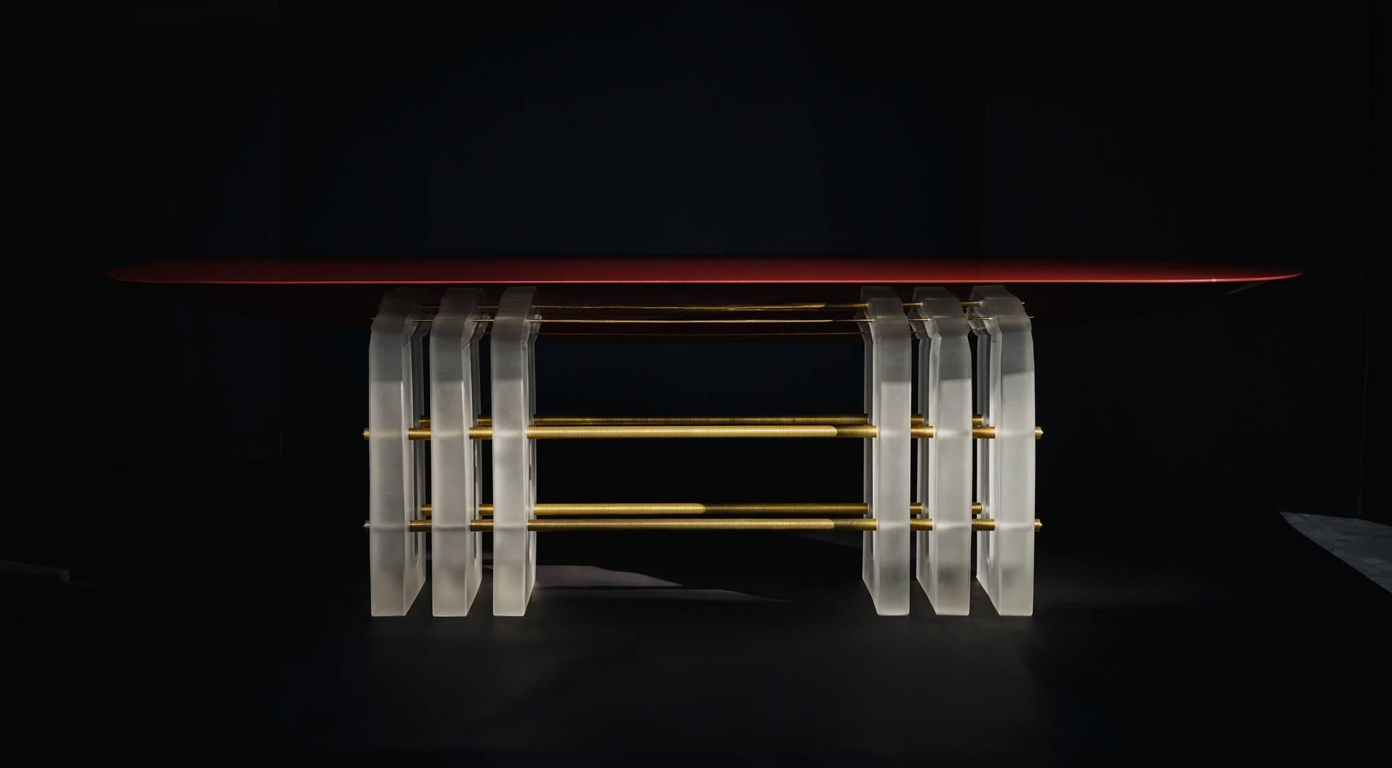 The translucent resin bases of the Segment series lift softly-rounded forms, creating a visual play between density and lightness. The underside of the lacquer table tops bulge as though being pulled back to the floor, anchoring one form to the