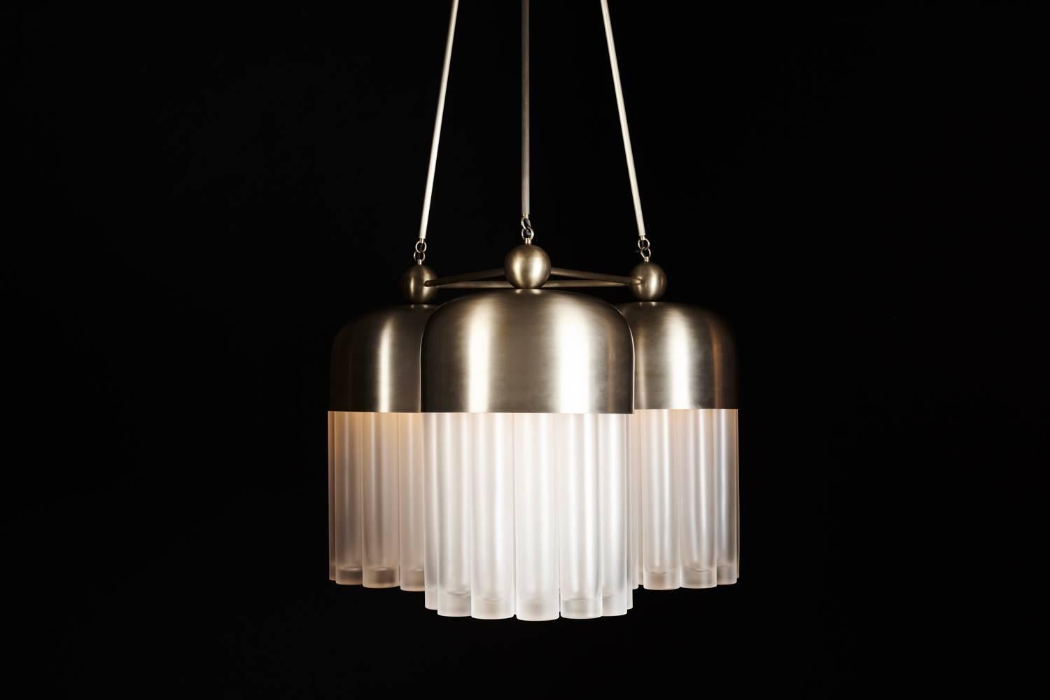 The Tassel series condenses the warmth and decadence of a traditional chandelier to a concise, modern conclusion. Emanating from a brass dome, the light is amplified as it refracts through mold-blown glass cylinders.
 