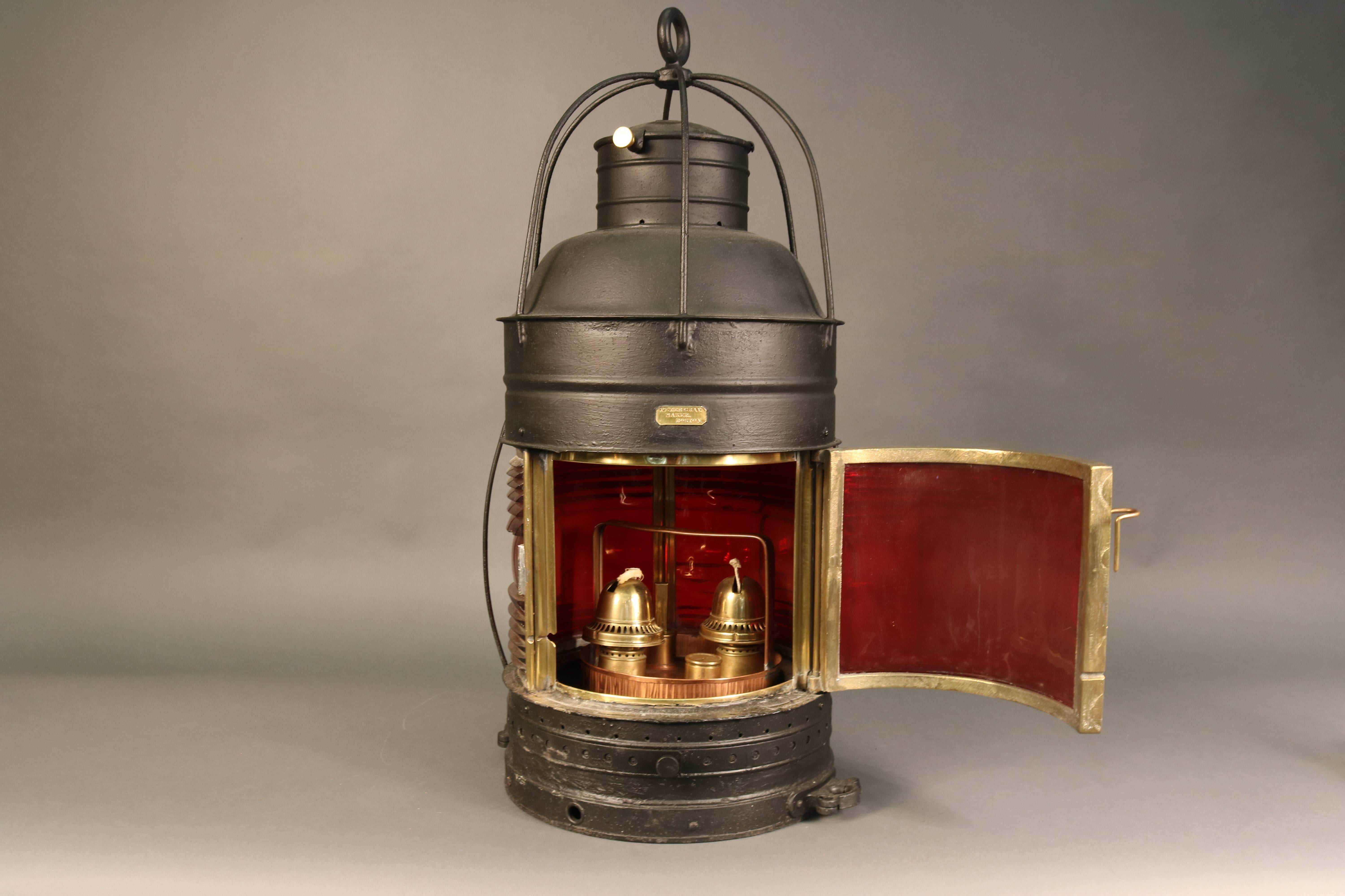 U.S. Lighthouse Service beacon by Peter Gray of Boston. Interesting and rare red beacon of iron construction with hinged door, mounting hardware and red paneled lens. Copper burner has two geared wicks, fill hole and gauge. Burner is by