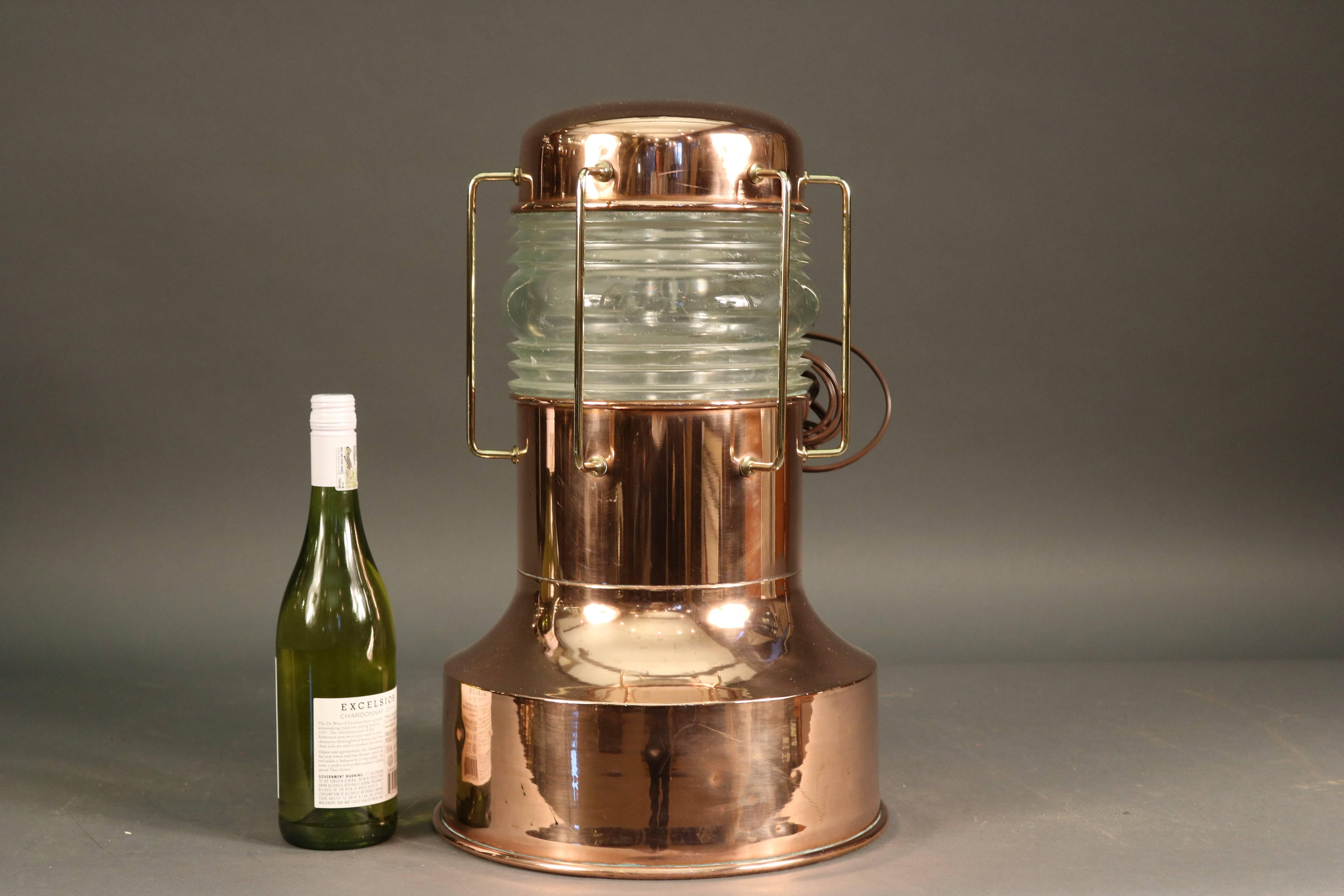 Solid copper pier light. Highly polished with clear Fresnel lens and protective brass bars.