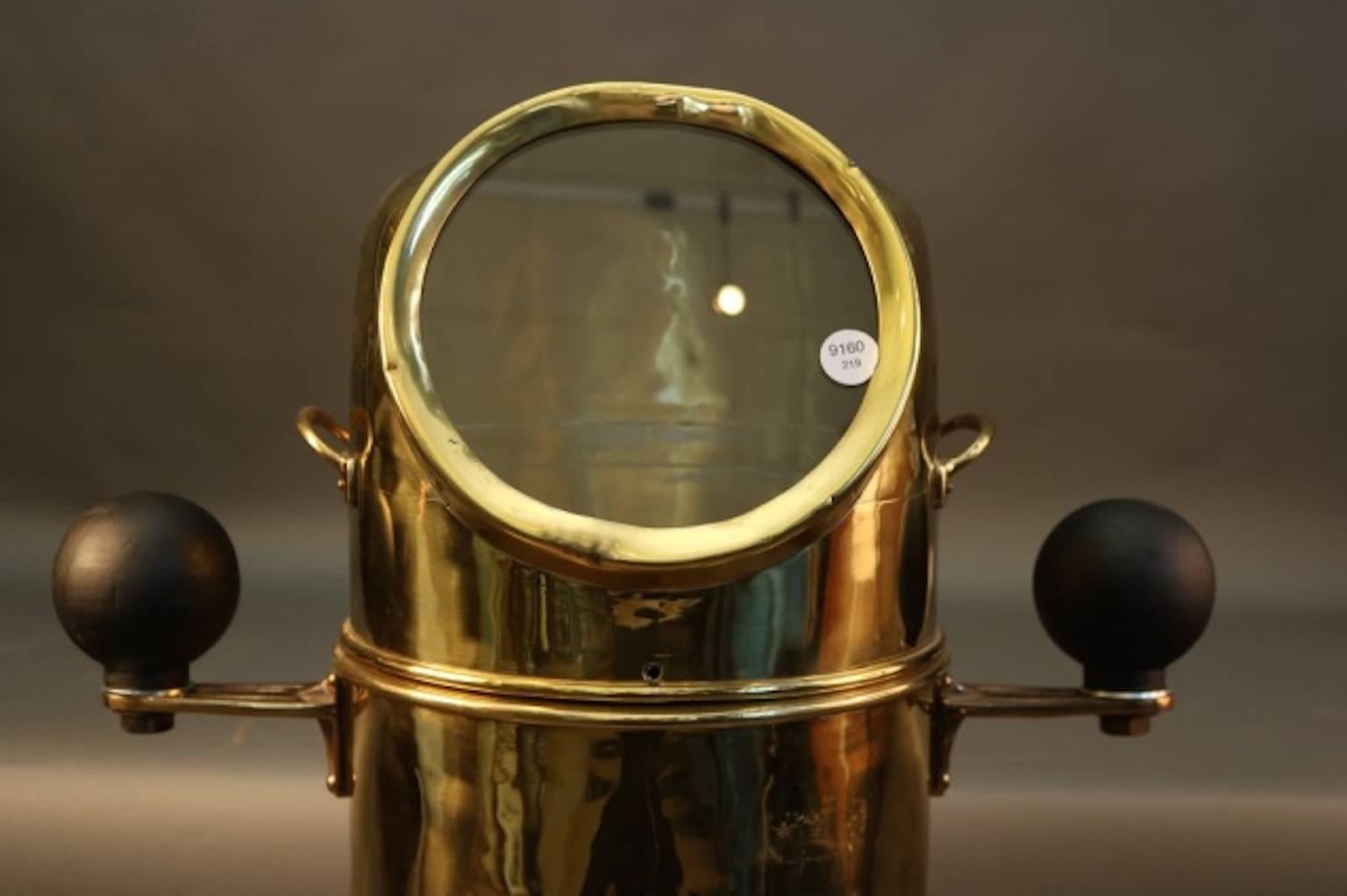 Unique small craft brass binnacle of a rarely seen design. With gimbaled compass, sturdy brass hood and base fastened to a circular hardwood base.