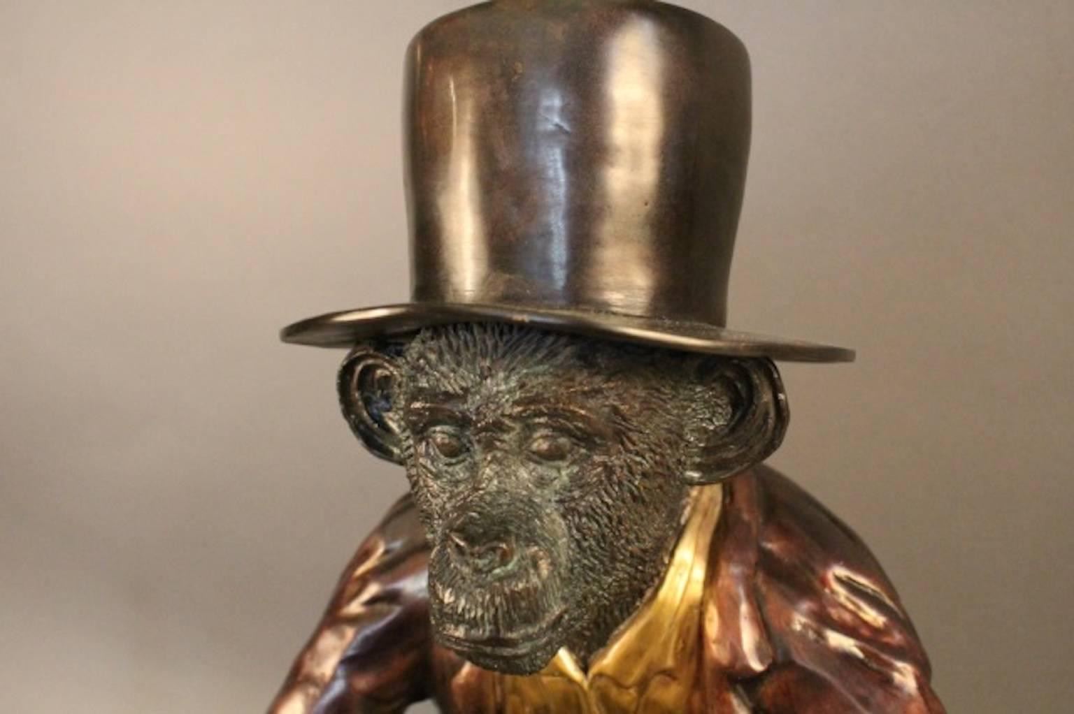 Wine cooler of cast bronze showing a monkey in top hat, topcoat, and vest holding a large ice bucket or wine cooler. Quite heavy. 
Overall dimensions: 11" L x 13" W x 24" H. 
Weight: 22 1/2lbs.