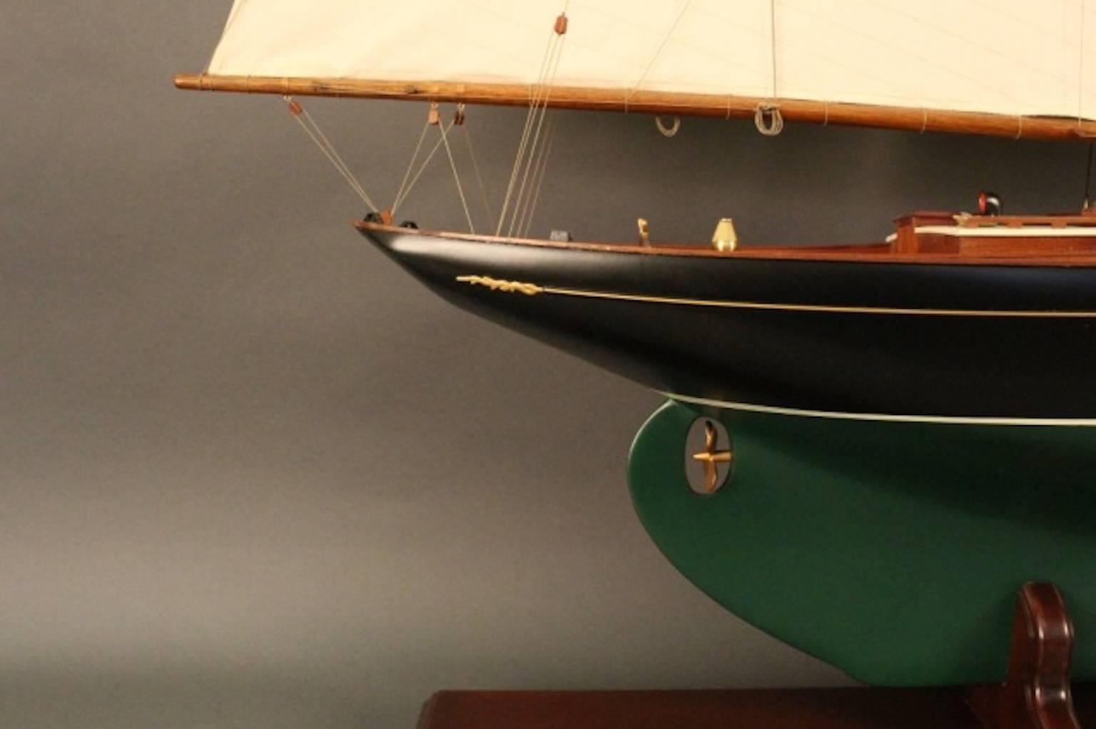A scale model of the John Alden designed schooner “Malabar X". The planked deck carries a long cabin with oval portholes, toe-rail, skylights, and companionways. Other details include an anchor windlass, stovepipe, anchor, binnacle, and helm,