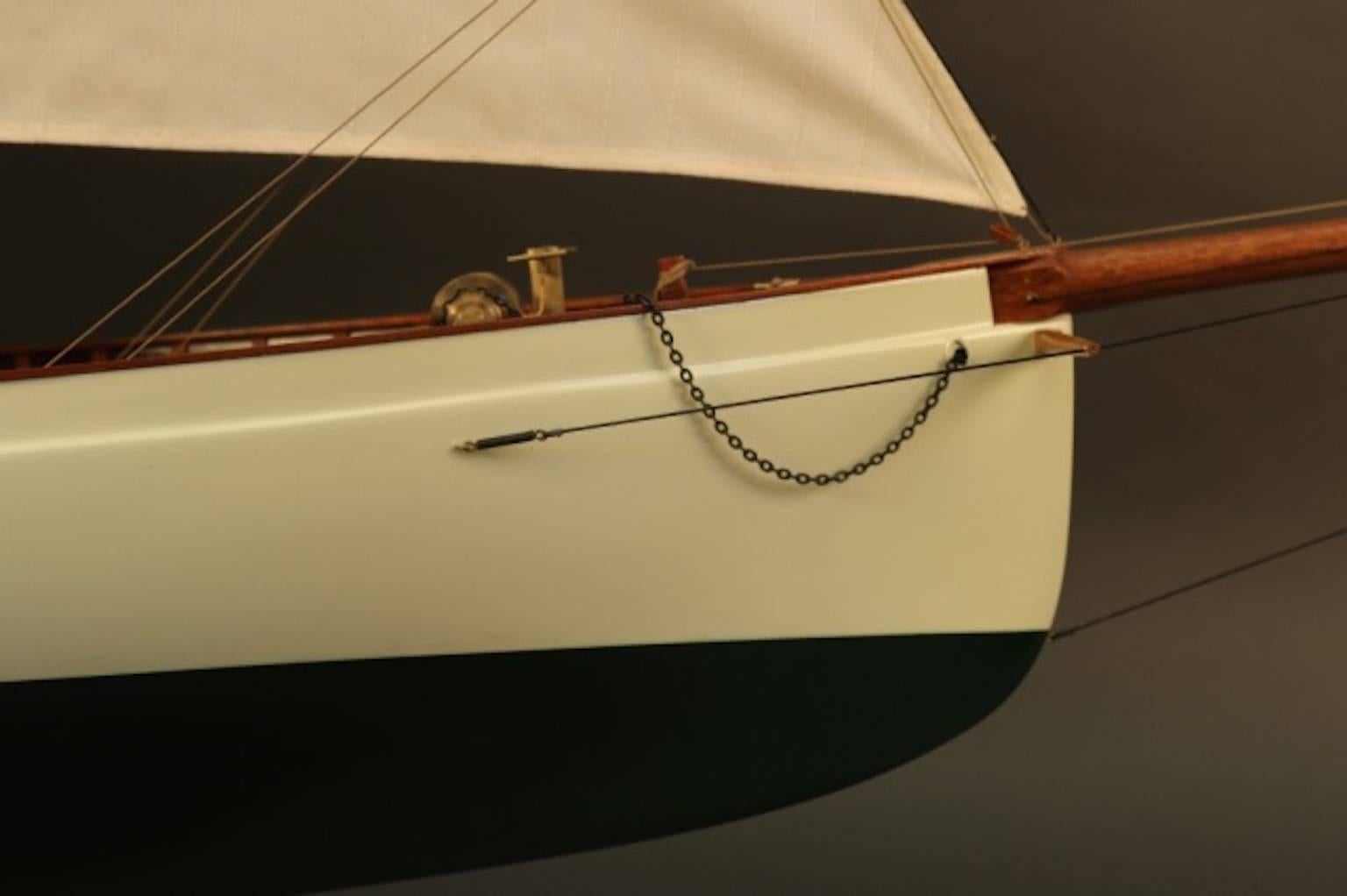 Expertly crafted model of the America's cup yacht "Puritan". Model is built with planked mahogany deck, skylights with brass bars, brass fittings, tiller, full suit of linen sails etc. No case.
Model dimensions: 73" L x 12" W x