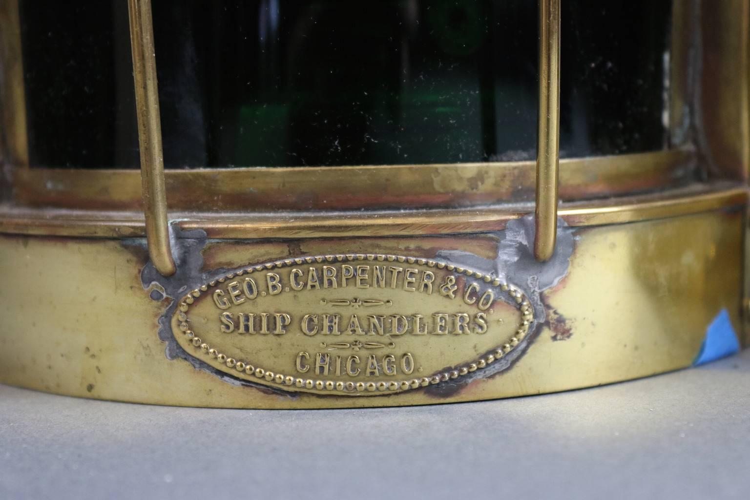 19th century yacht port and starboard lanterns with brass protective bars, vented tops and carry rings. Both with maker's labels from George Carpenter & Co., Ship Chandlers, Chicago. Dimensions: 6.5" L x 5.5" W x 10" H (with or