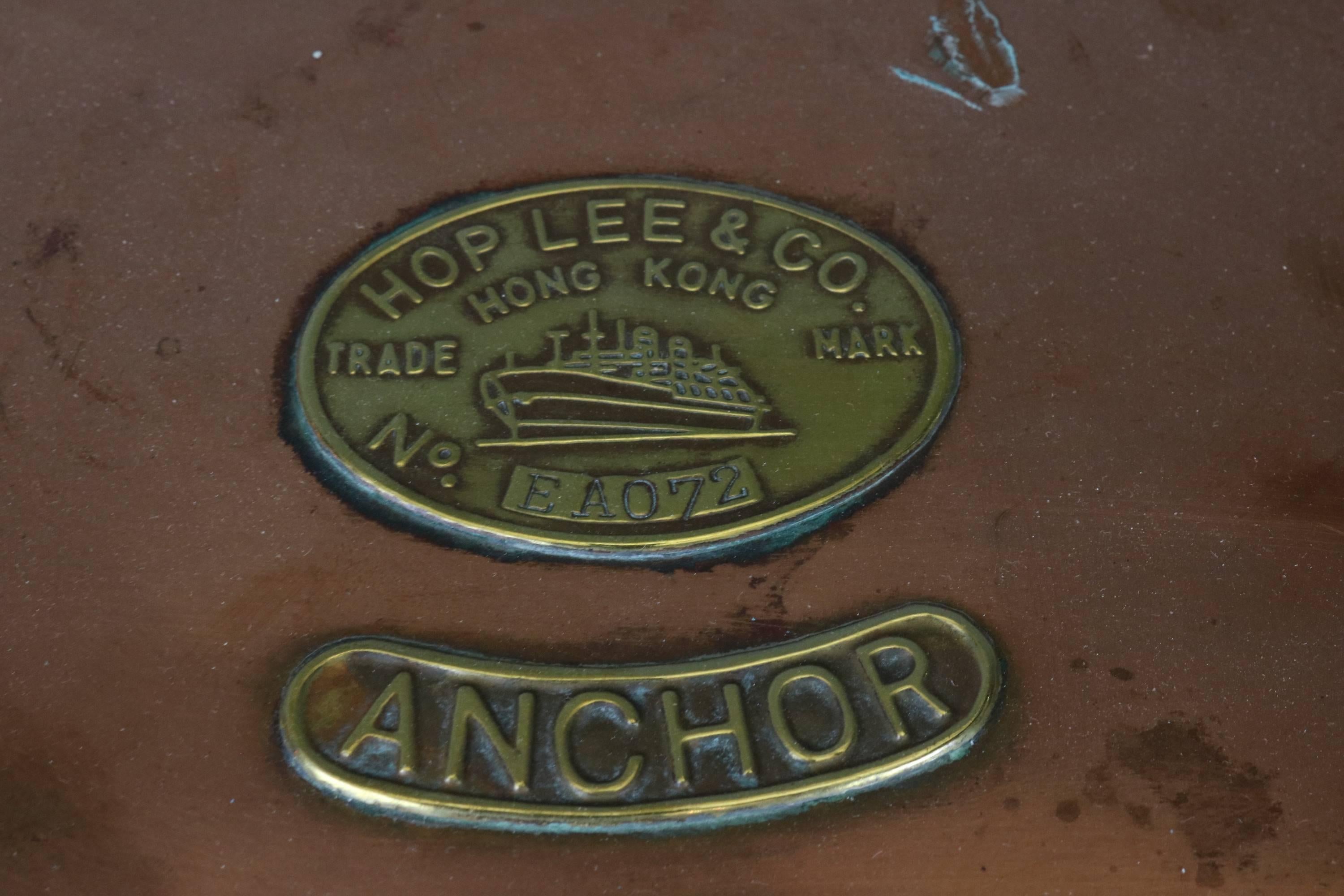 Copper anchor lantern with brass maker's badge from Hop Lee & Co., Hong Kong. Fresnel glass lens, brass bars, hoisting handle, etc. 

Measures: 14" high x 11" diameter.

