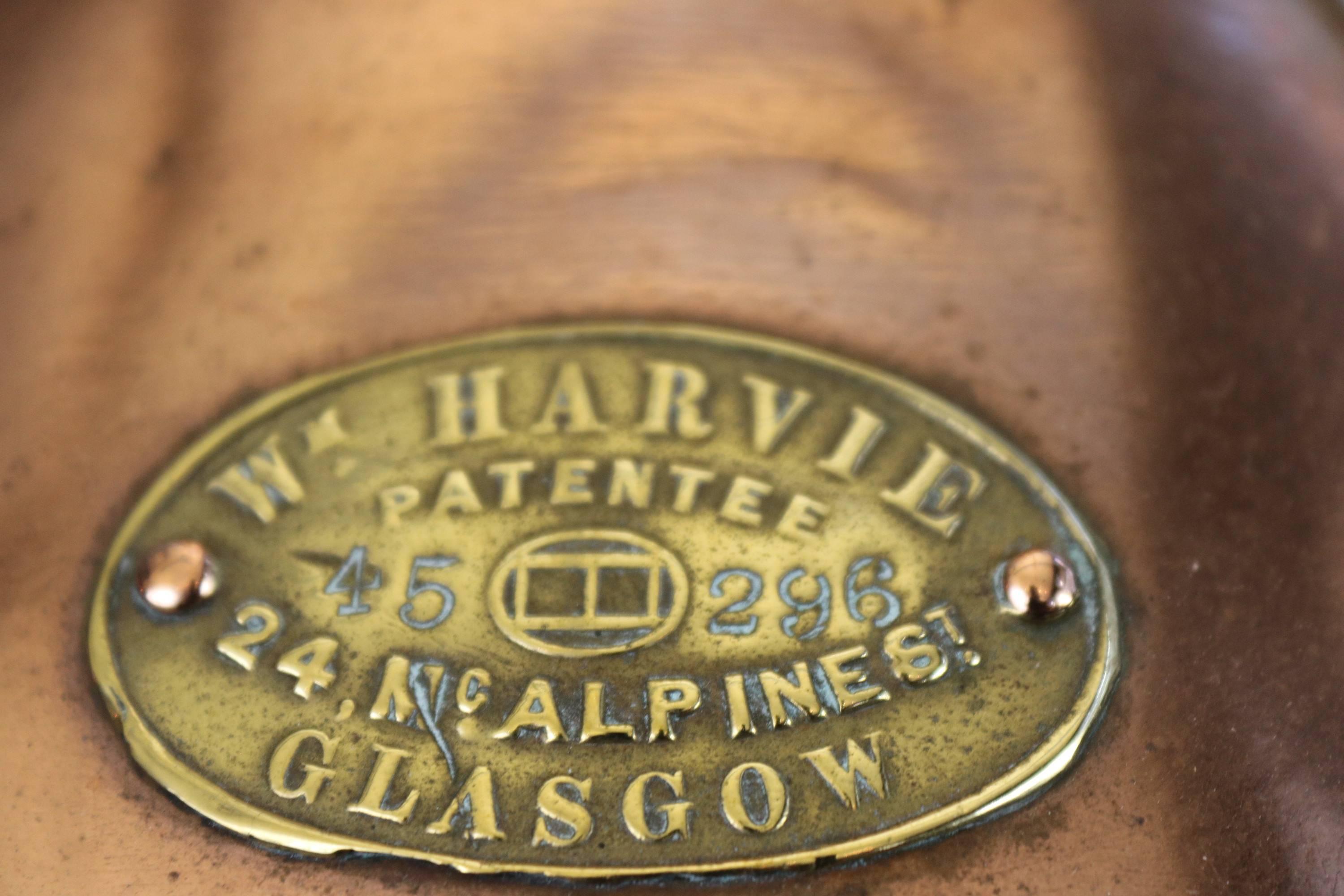 Solid copper and brass starboard ship's lantern. Heavy fresnel glass lens. Brass maker's badge from William Harvie, 24 Alpine St. Glasgow. Brass carry handle, solid brass hinges on top with knurled knob. Measures: 27 x 11 x 12.