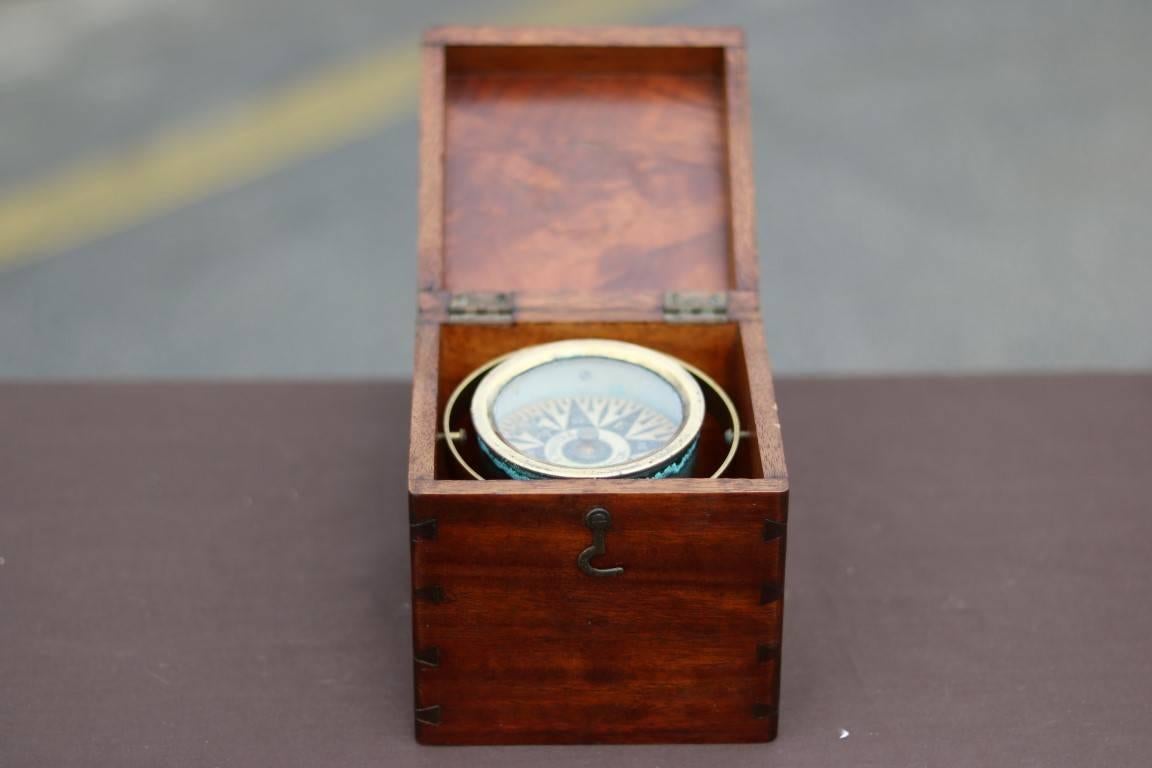 Brass gimballed compass fastened to dove-tailed wooden box by Thaxter and Son of Boston. Dry compass card. Dimensions: (box) 5