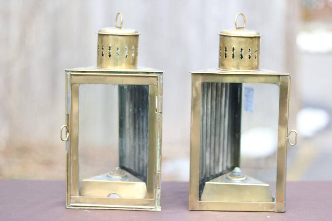 Pair of triangular brass cabin lights. Hinged doors. Not electrified. Dimensions: 6.5" L x 12" H (without handle).
