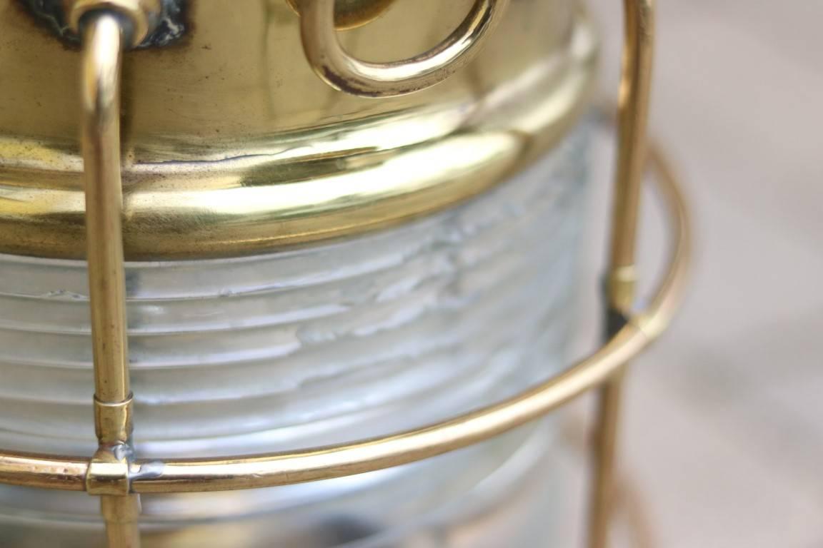 Brass anchor lantern by Perko. Fresnel lens has some loss.

Dimensions: 20" H x 10" diam.

 
