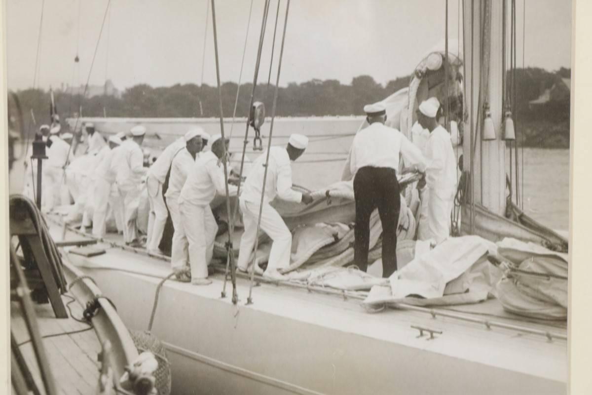 Authentic associated press photo, dated August 29, 1930 of the crew of the America's Cup yacht Enterprise. Adjusting the main sail, in preparation for its race against Shamrock V. Matted and framed.
Dimensions: 7" H x 9" L.
Framed