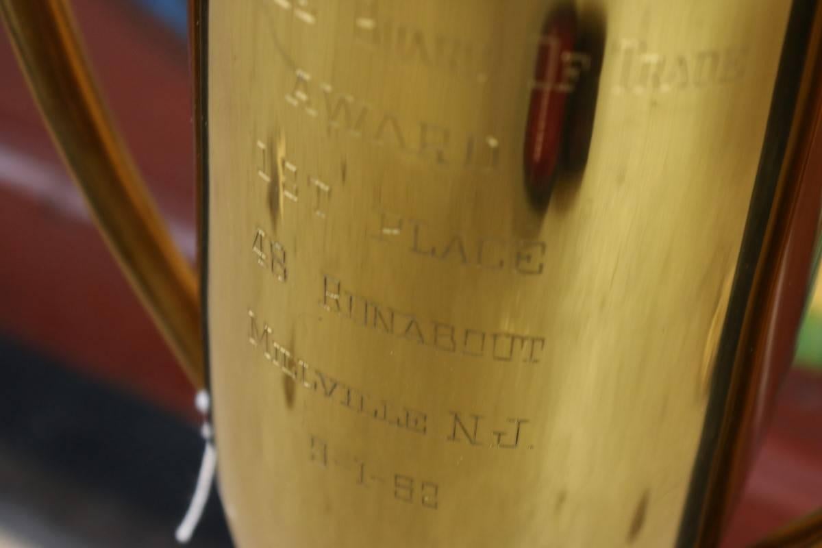 Speedboat trophy from 1952. Engraved "Millville Board Trade, Award 1st Place. 48 Runabout, Millville, New Jersey". Resin base. Dimensions: 23" H x 9" W.