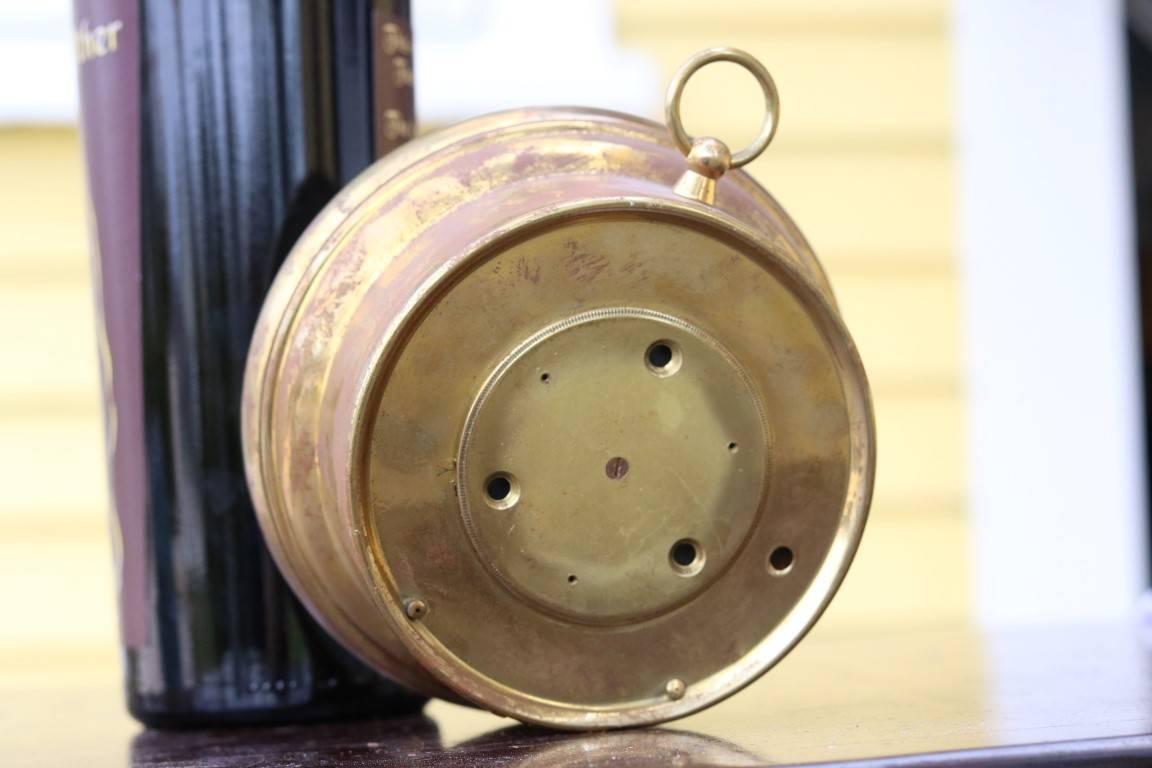 Stormguide by Taylor, circa 1922. Measures barometric pressure with detailed readings such as "very stormy", "high winds", "southeast rains" and etc. Brass housing shows wear. Hanging loop. 

Dimensions: 5.25"