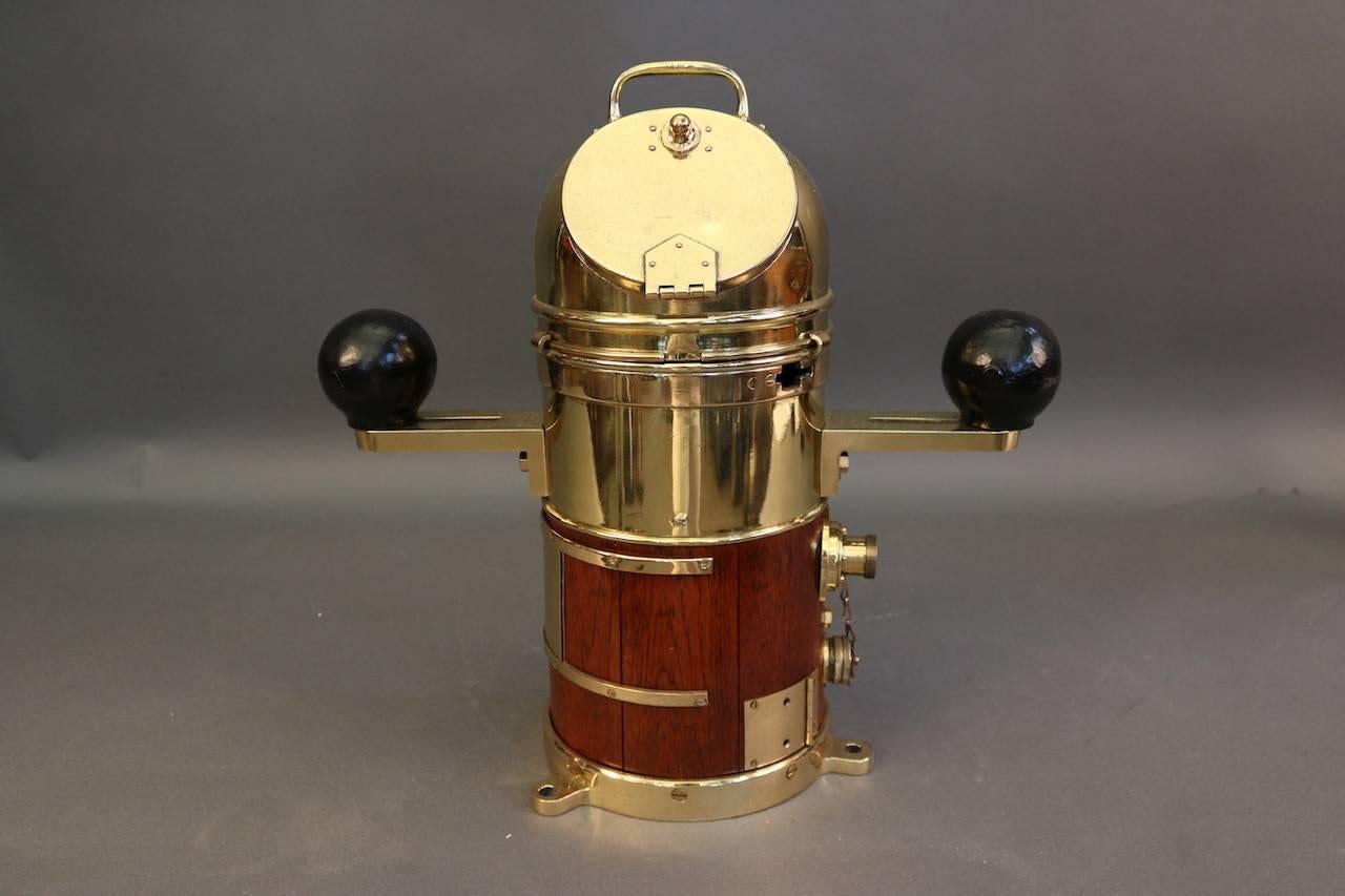 Ship's binnacle with brass casing, a compass on gimbal, and iron compensating magnets on a wood base.

Overall dimensions: 19" H x 18" W.