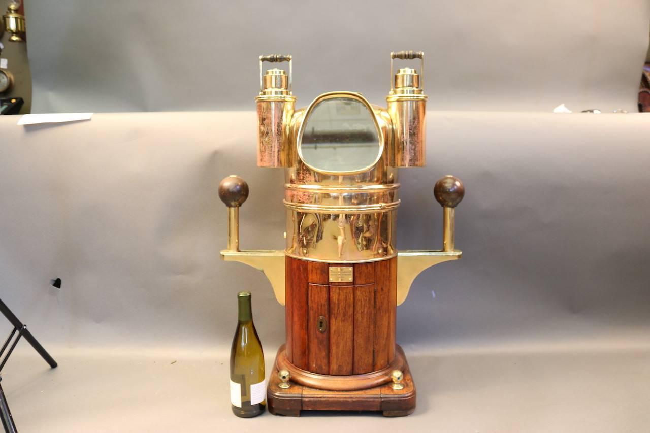 Antique compass binnacle by Ritchie with a brass case, side burners, magnetic compensating spheres, and a wooden base. Made by Joh Gulbransen Instrument Maker, OSLO.

Overall dimensions: 33 1/2" H x 24" W x 10" D.