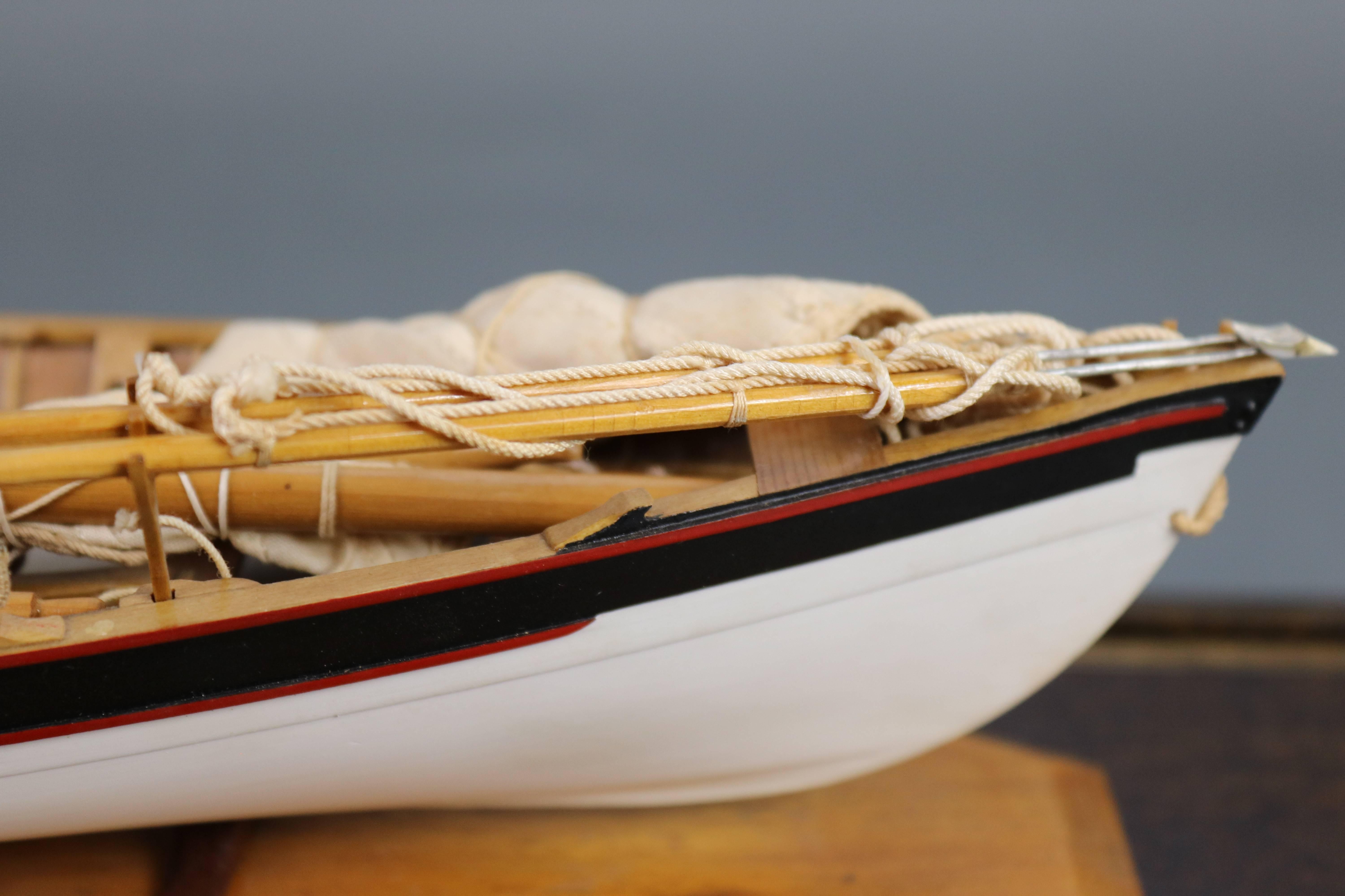 Expertly crafted model with ribs, planks, floorboards, oars, lances, harpoons, and etc. Fitted to an inlaid display case. Dimensions: 24" L x 8" W x 9" H.