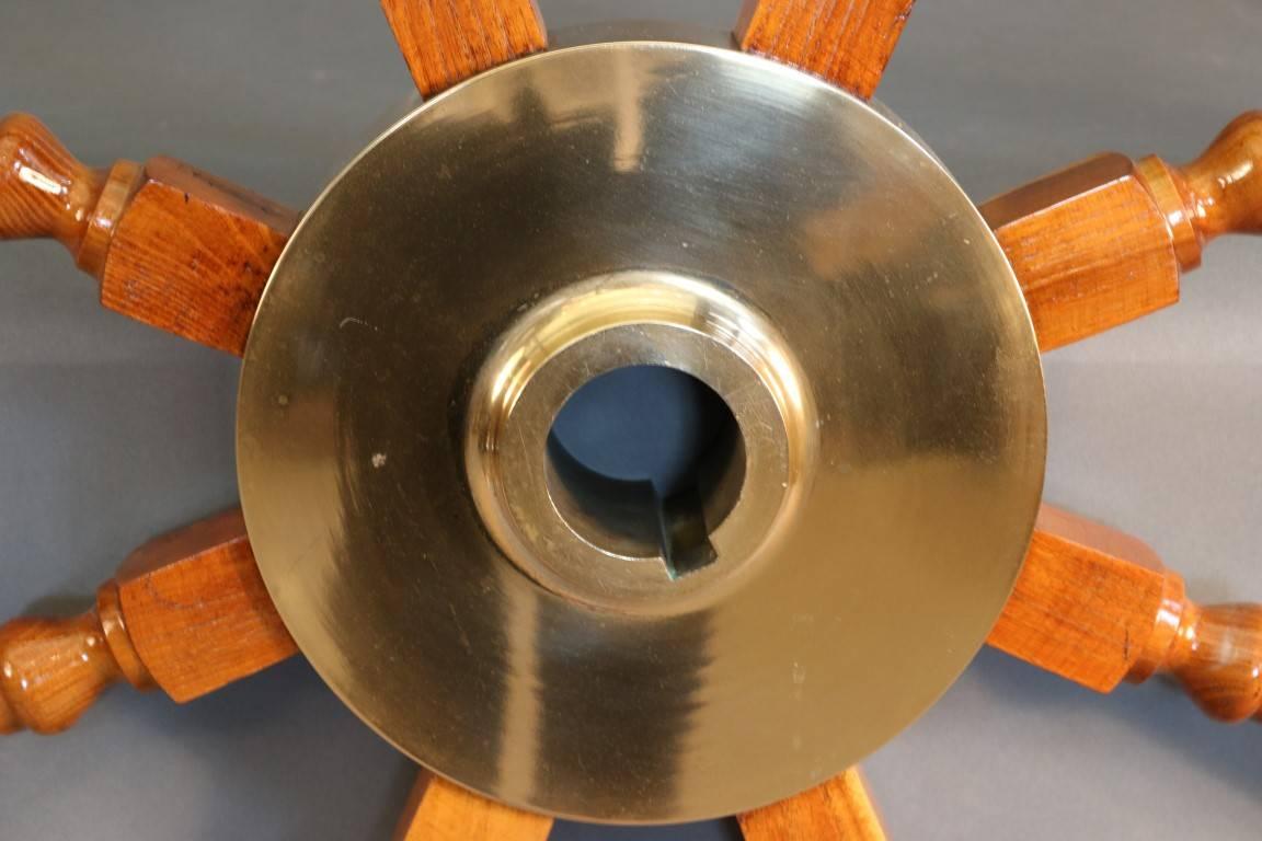 Early wooden yacht wheel. Eight spokes. Brass hub. Alternating wood inlay pattern. Overall dimensions: 57