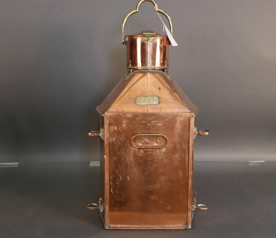 Size: 24" x 11" x 12" (depth)
Finish: Copper and brass
Period: Early 20th century
Manufacturer: Meteorite
Polish: Matte to glossy
Lens: Clear Fresnel
Detail: 
Flat back
Sliding rear door
Burner inside
Hinged chimney