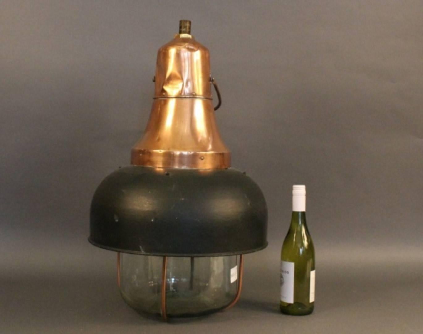 Large hanging light with copper housing and hood. Glass jug as a bulb cover with protective bars. Unusual design. Overall dimensions: 32