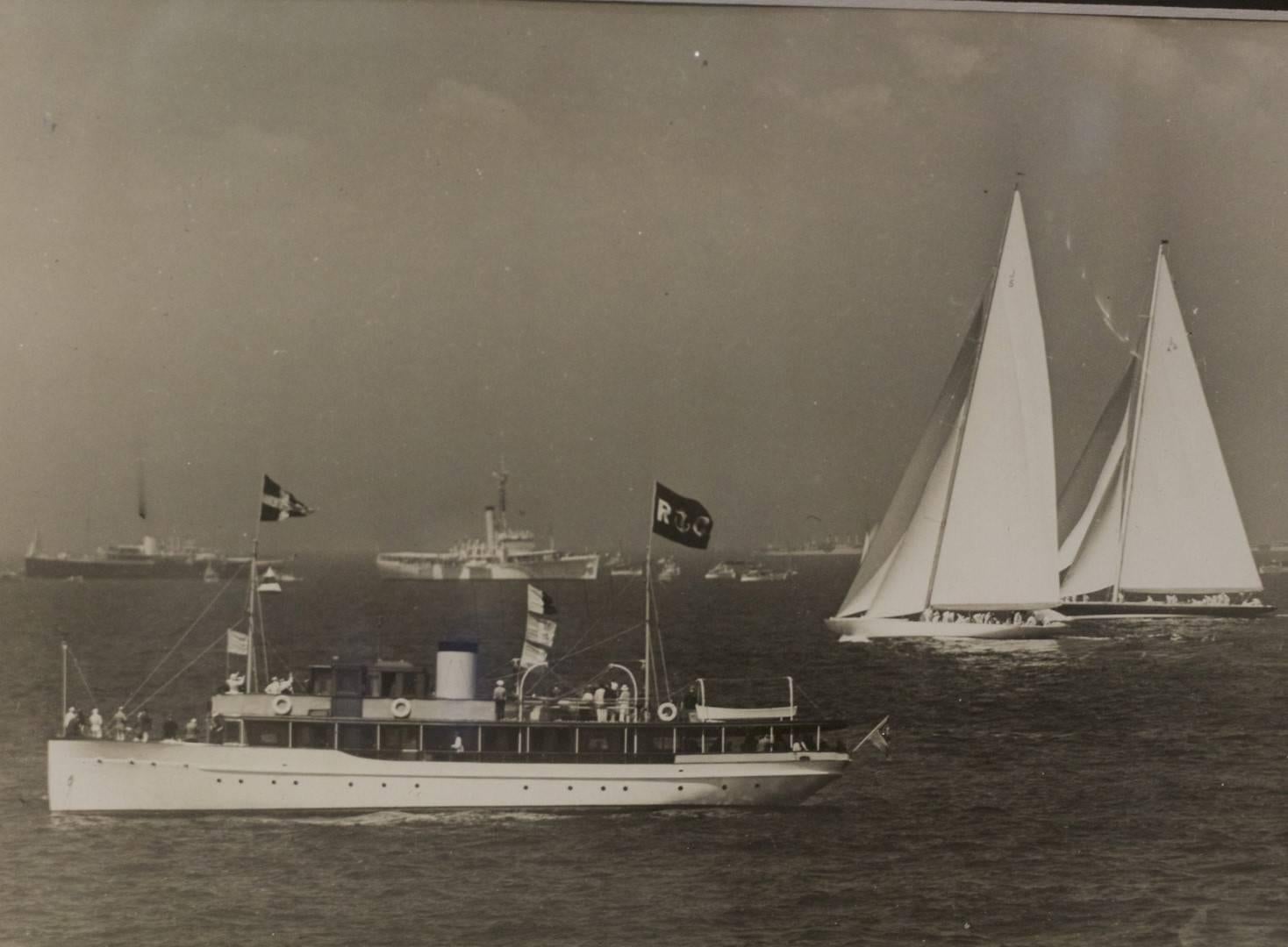 Original press photo showing the America's Cup yachts Ranger and Endeavour II, from 1937. Photo is from article, highlighting 3rd race of Newport of America's Cup series. Also shows spectator fleet. Matted and framed. Dimensions: 12