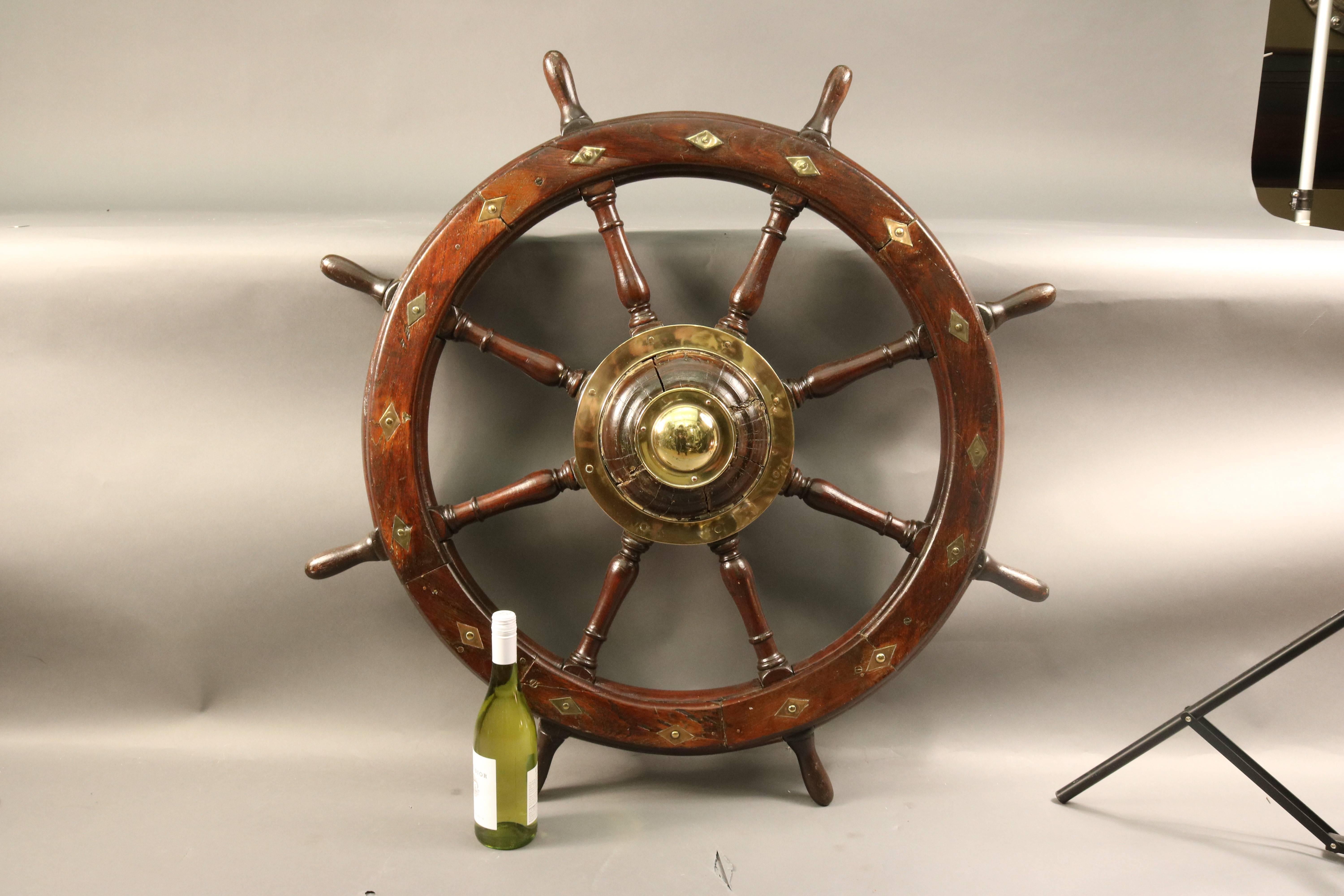 Early 19th century wooden ships wheel with diamond shaped brass inlay and wood hub. Wood hub places this item in the early 1800s.