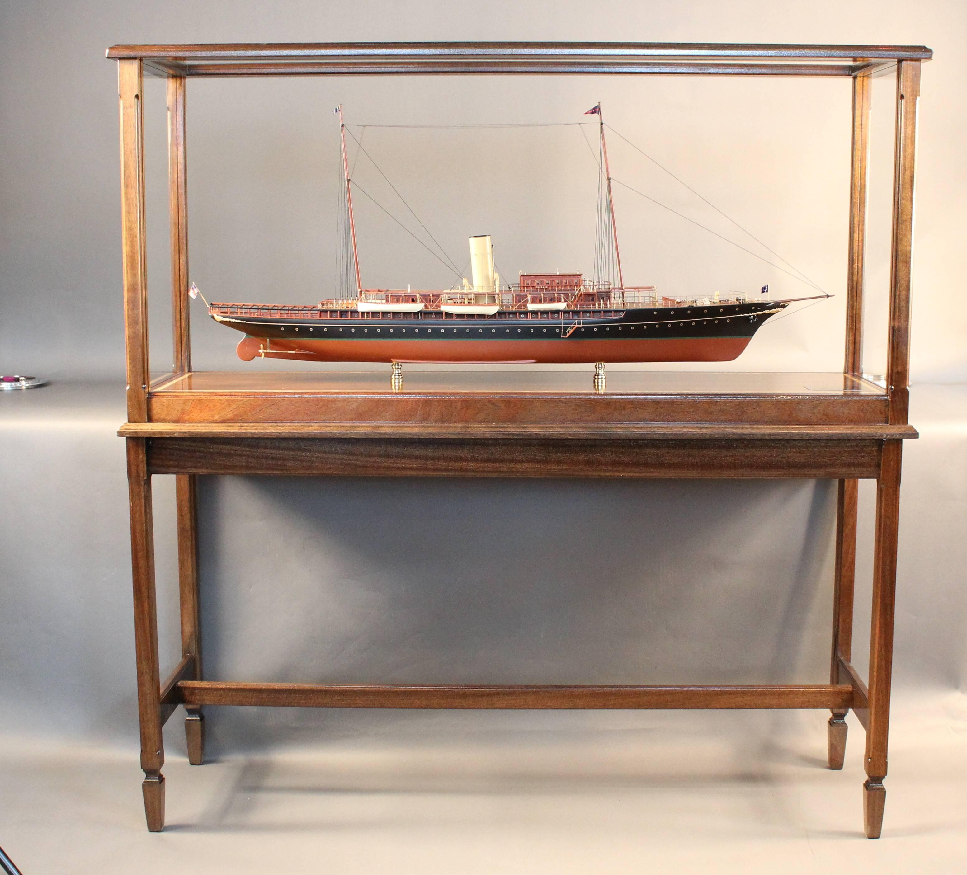 Steam yacht model of J.P. Morgan's "Corsair IV" mounted into a custom glass and mahogany display case with table. 
This model is outfitted with raised paneled mahogany cabins, planked deck, turned brass fittings, rigged masts etc...