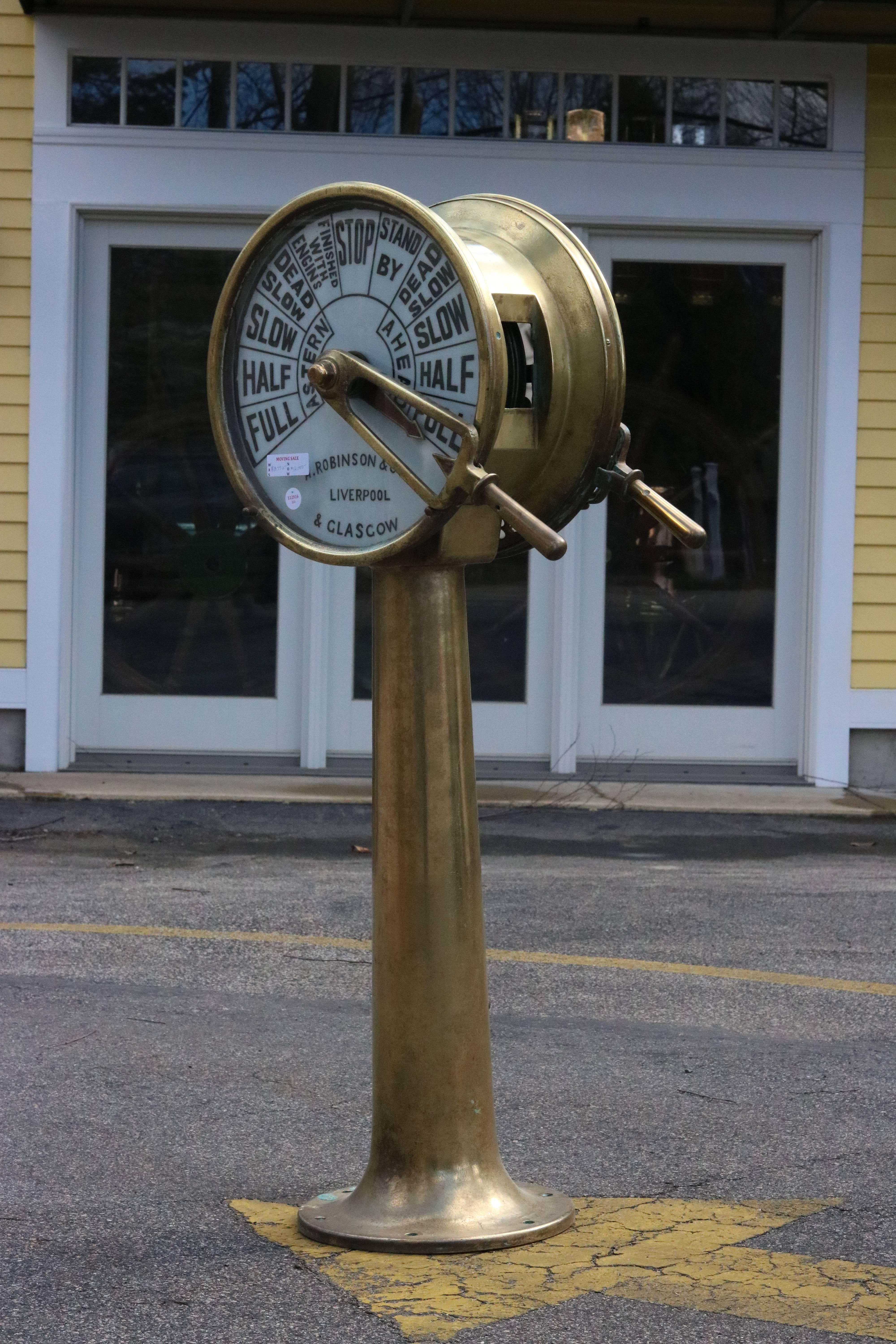 Brass telegraph by A. Robinson Co, Ltd of Liverpool and Glasgow. Doubled porcelain faces with handles that chime. Reads standard commands. 