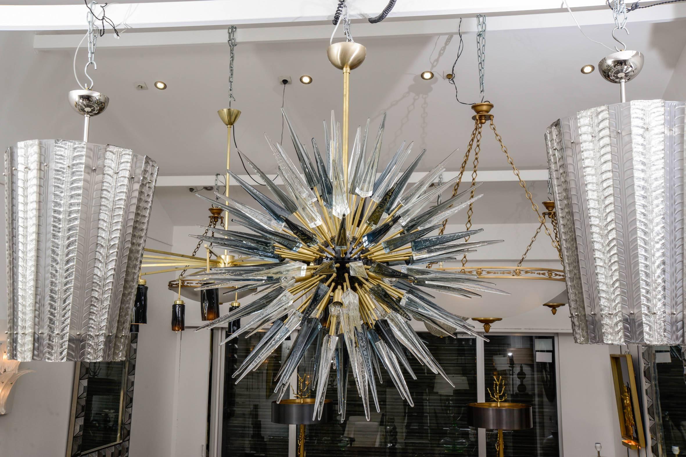 Italian Sputnik chandelier in spiked smoked grey, amber color and clear Murano glass (118 elements). Murano blown glass in a traditional way.
With brass fixture and center of sphere.
12 bulbs.
  