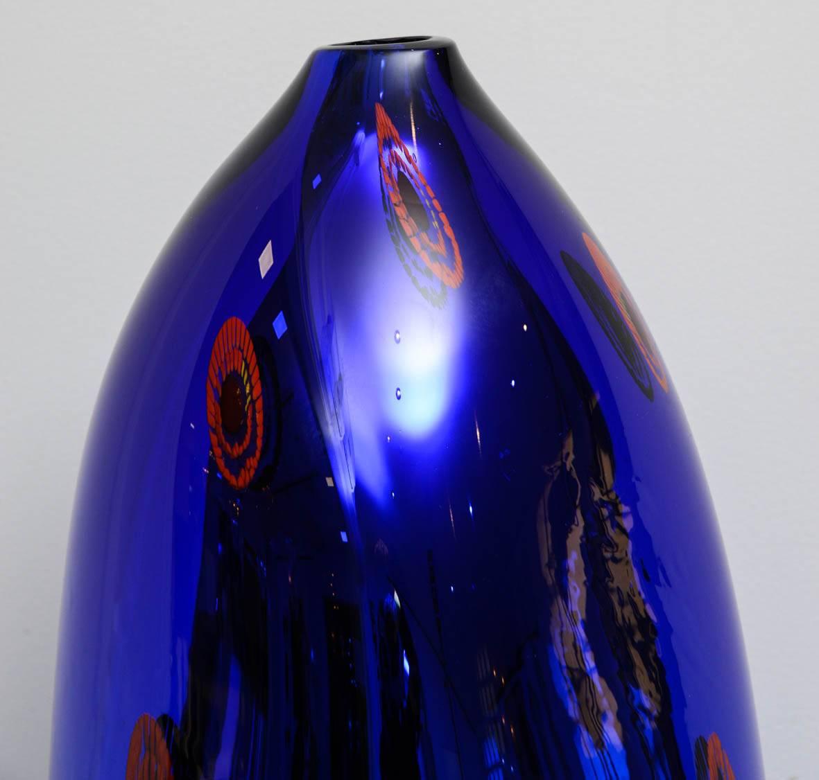 The vase is signed, one-off, in perfect condition, blue Murano glass, free-form, with red murrines inclusions.