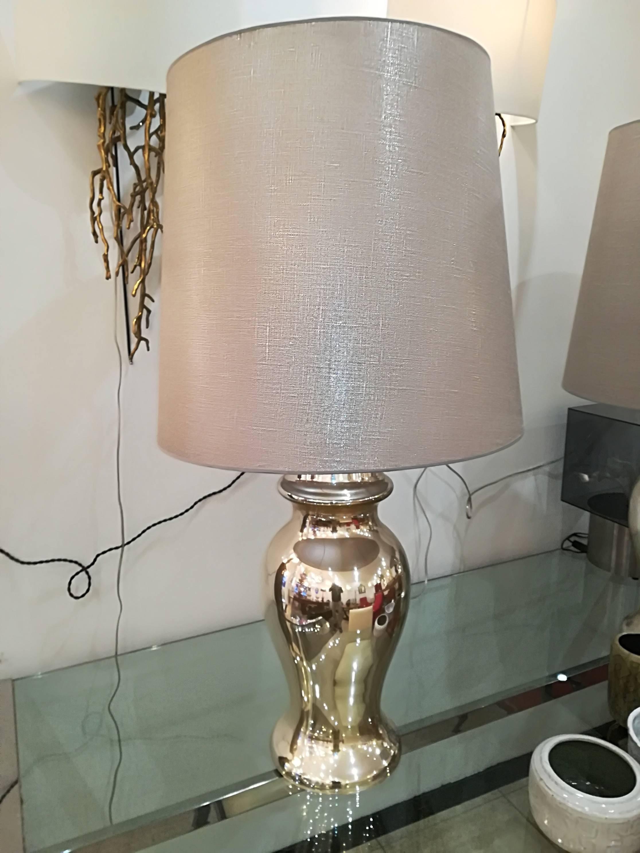 Beautiful pair of eglomized  (silver with with golden highlights ) table lamps, in excellent condition, provided with lampshades.
Dim lamp stand only : 57cm